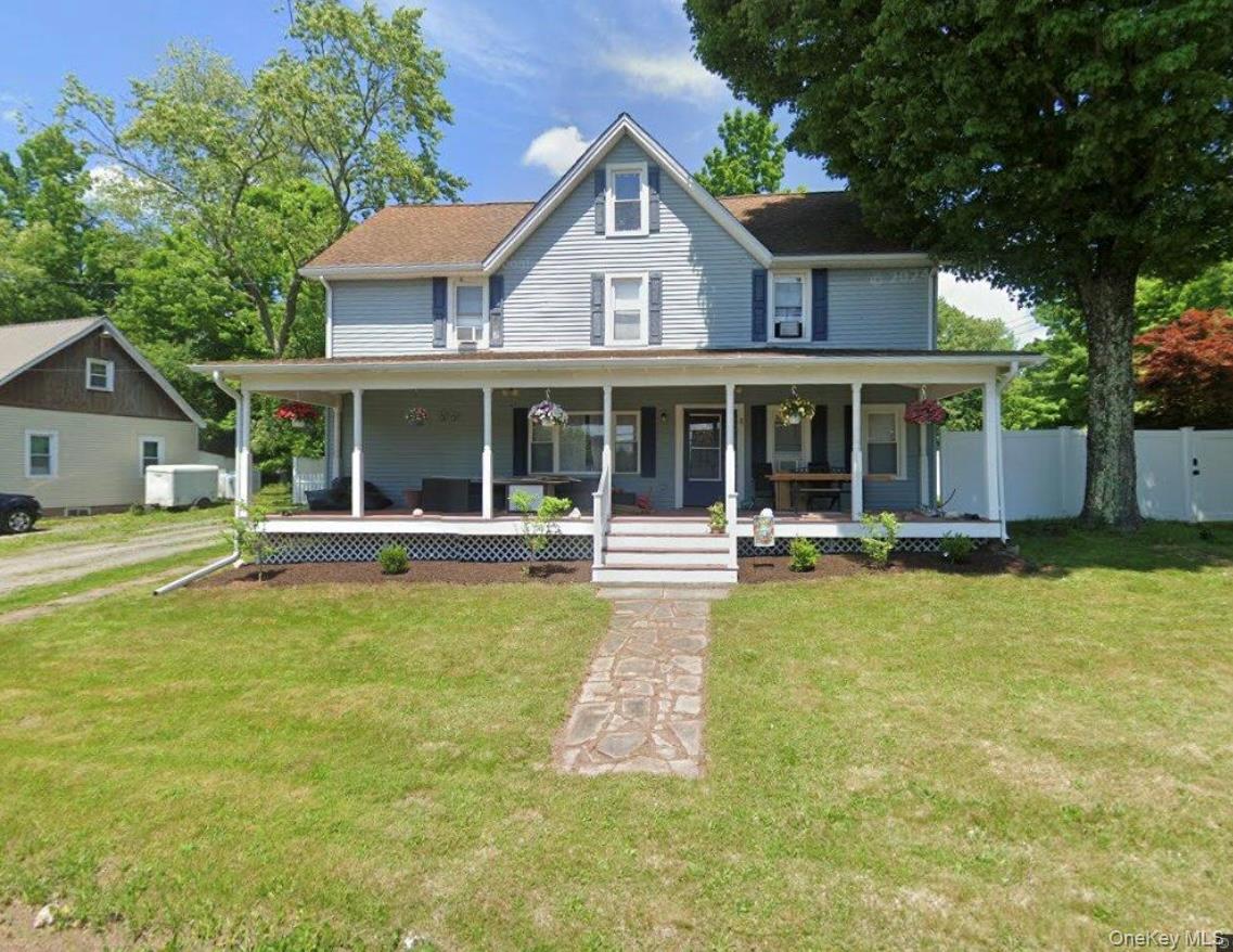 Farmhouse featuring a large porch