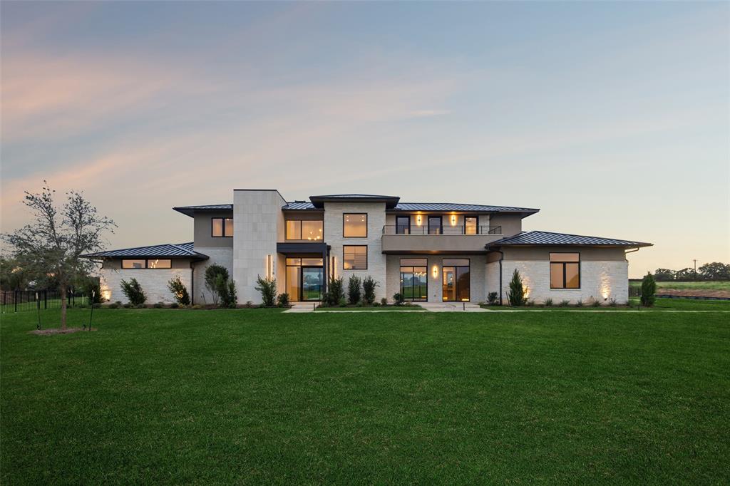 Sellers are offering a $100,000 Builder credit towards upgrades or closing costs! Welcome to an architectural masterpiece in Bartonville’s prestigious Eagle Ridge, designed by Lingenfelter Luxury Homes! Perfectly set on more than 2 acres of fully irrigated & landscaped grounds framed by mature trees & a secure fence, this 5-bedroom estate combines sophistication, comfort, and unrivaled lifestyle amenities in a setting of privacy & prestige. A striking Iron & Glass front door & window wall invite you inside, where soaring ceilings, 5 inch White Oak HW & walls of windows bathe the open, flowing layout in natural light, seamlessly blending indoors w-outdoors. Chef’s kit is the heart of the home, appointed w-Wolf gas cooktop, dual ovens, quartzite, Sub-Zero refrigerator + Butler’s pantry. Entertain w-ease in the expansive living room anchored by a grand stone FP, the game room, or the dining area w-dual wine refrigerators. Primary suite is a retreat unto itself, offering a spa-worthy bath w-garden tub, dual vanities, coffee bar + dual custom closets. Each bedroom boasts its own en-suite bath. Distinctive features include a Classic Series LLT-952 Traction Elevator,  Phantom Screens, a dedicated office, exercise room, fire sprinklers + a 5-car garage. Climate control is uncompromised w-4 multistage Lennox HVAC systems, linear slot diffuser grills + a fully encapsulated foam AC envelope. Outdoors, a standing seam Class 4 metal roof shelters the home while multiple patios—one with a full outdoor kitchen featuring a 42 inch Coyote gas grill + fridge—set the stage for year-round entertaining. Resort-inspired backyard boasts a temperature-controlled pool + heated spa, an outdoor brick FP & tranquil spaces designed for relaxation. Ideally located in Eagle Ridge, residents enjoy proximity to Argyle ISD, Liberty Christian, Ponds, acclaimed dining at Marty B’s, premier golf at Denton Country Club & Lantana Golf Club + the recreational waters of Lake Lewisville & Lake Grapevine.