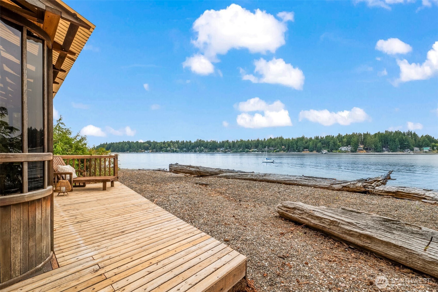 A Gentle Life by the Sea!  5 acres with 175 feet of West Facing, No Bank, Sandy-pebble beach, this Case Inlet treasure is an invitation to a slower, richer life. A place where sunsets paint the sky behind the Olympic Mountains & the tide delivers treasures to your feet. The home feels like a beloved heirloom—a timeless blend of rustic cedar with soaring ceilings, creative built-ins, & antique charm. Fireplaces in both the living room & primary warm the home year-round, while the wisteria canopied wrap around deck, gardens & greenhouse, private pond, fabulous beach cabana, & 1500 sf shop expand your world outdoors.  Life here is abundantly peaceful, cozy, inspiring, & kissed by salt air—a coastal hideaway in every sense of the word.
