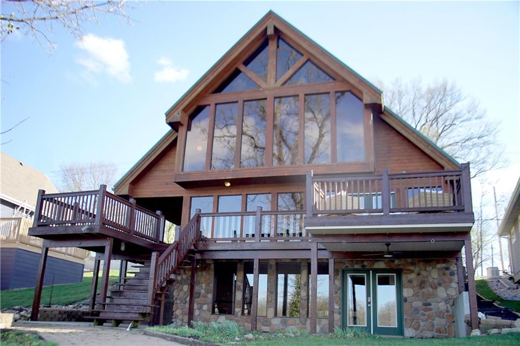 Some properties offer a place to live. This one offers a way of life.Nestled on the shores of Lake Tapawingo, Cabin Tapawingo is a rare lakefront sanctuary where sweeping 180-degree water views, effortless entertaining, and the timeless charm of an A-frame retreat come together in perfect harmony. From front-row Fourth of July fireworks to peaceful mornings with sunlight dancing across the water, this home is built around unforgettable moments.A Home Built for GatheringWith 4 bedrooms, 2 additional flex sleeping spaces, and multiple generous living areas, there’s room for everyone. A fully self-contained mother-in-law suite with its own kitchen and living space offers the perfect balance of togetherness and privacy for guests or extended stays.A Primary Suite That Redefines Waking UpEnjoy panoramic lake views every morning from the comfort of your primary suite, complete with ample closet space and a stunning 180-degree vista year-round.Entertain on Every LevelThe walk-out lower level features a full bar, restroom, and direct lake access, creating seamless indoor-outdoor living. Outside, your private dock with an upper tanning deck is made for long summer days on the water.Move-In Ready, Timeless CharacterFreshly restained siding and decking enhance the home’s classic lake cabin charm. With a two-car garage, parking for 4+ vehicles, and just 22 minutes to downtown Kansas City via I-70, you get the best of both worlds.The OpportunityTrue lakefront homes like this are rare. Cabin Tapawingo is more than a home, it’s a legacy property and a place to gather for years to come.Your lake life starts here.