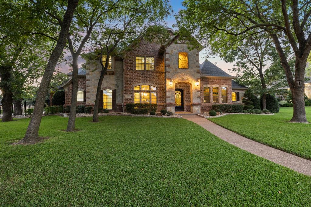 Experience resort-style living in this extraordinary home, perfectly nestled on a serene .62-acre lot within award-winning Keller ISD. Offering 4 bedrooms plus a private office, 2 living areas downstairs, 2 dining areas, media room, game room and an electric gated driveway leading to a 4-car garage. The backyard oasis is a showstopper with a sparkling resort style pool and waterfall, spa, outdoor kitchen, expansive covered patio with fireplace & a sprawling landscaped lawn. With 4 full baths & 2 half baths for guests. This home truly has it all. Replaced HVAC units in July 2025 for peace of mind & comfort. Other updates incl. ice machine in 2022, dishwasher in 2023, pool remodel including pump & controller equipment in 2022 & electric gate wireless controller, operator arm & solar charging in 2024. Inside, hand-scraped hardwoods grace the entry & main-level living & dining areas. The luxurious primary suite boasts a spa-like bath & oversized his-and-hers closets. A second bedroom with full bath downstairs is perfect for multigenerational living. At the heart of the home, the chef’s kitchen features a 6-burner gas range with pot filler, built-in refrigerator, rich custom cabinetry, flowing seamlessly into the breakfast area & impressive family room with stone fireplace. An additional living area with soaring ceilings & abundant natural light enhances the open, airy feel. Upstairs, enjoy movie nights in the fully equipped media room or gather in the spacious game room with kitchenette. Two oversized bedrooms, each with its own bath, complete the second level. Step outside to your private paradise that feels like a luxury getaway! Beautiful trees provide great shade for outdoor entertaining. This home is a true masterpiece blending timeless elegance, superior craftsmanship & stunning architecture. Excellent location with access to scenic walking trails & parks, minutes to Keller Pointe Rec center & nearby family friendly activities at Keller Main Street & City Center.