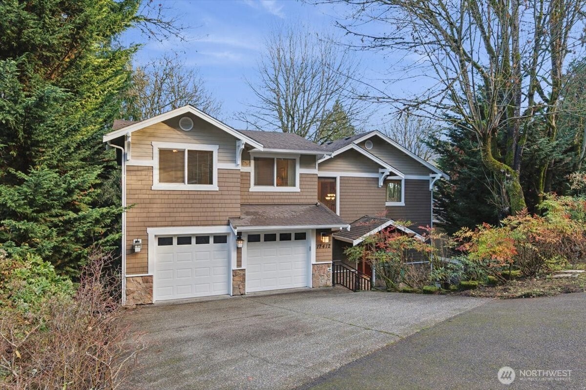 Step inside this extraordinary home where treehouse charm meets lodge-like warmth & rare privacy. Quietly tucked off the street on a large street-to-street lot, it offers a park-like setting, an expansive private deck & patio, newer windows, a new Carrier furnace, & recently added central AC. Xtra off-street prkg. The main floor features a great-room layout w/large view windows & fresh paint. A lower level 6th bedroom functions beautifully as an office with built-ins and a Murphy bed. The lower level includes a gas fireplace & walk-out patio, plus abundant storage. Deeded access to the Lake Forest Park Civic Club(beach access/dock/picnic), top-rated Shoreline schools, & a short walk to Town Center shops & dining. Welcome home to the Park!