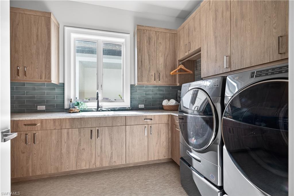 Laundry area with independent washer and dryer and cabinet space