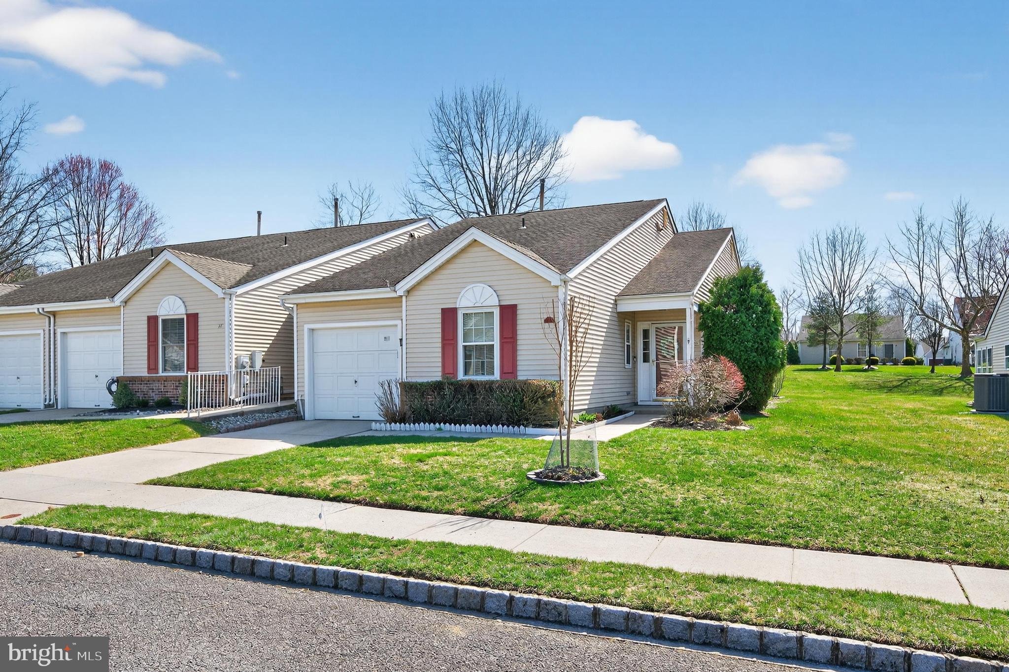 Welcome to 12 Yarrow Place in the highly desirable 55+ community of Holiday Village East, where comfort, convenience, and low-maintenance living come together beautifully. This move in ready, spacious carriage home offers over 1,500 square feet of well-designed living space featuring 2 bedrooms and 2 full bathrooms, in a quiet cul de sac location ideal for those seeking both everyday comfort and room to entertain. From the moment you enter, you’ll notice the neutral, freshly painted interior, enhanced by new luxury plank flooring and recessed lighting that create a bright, welcoming atmosphere throughout the home along with the many  windows adding to the open feel. The thoughtful layout provides generous living and dining areas, perfect for relaxing with family or hosting friends. The spacious eat-in kitchen offers granite counter tops, excellent cabinet and counter space along with brand-new stainless steel GE appliances, making meal preparation both convenient and enjoyable.  The kitchen flows into open family room with windows giving a view of the spacious back yard and patio area. The primary bedroom suite is designed as a comfortable retreat featuring a separate dressing area, spacious closets, and an en-suite full bathroom. A second bedroom provides ideal accommodations for visiting guests, hobbies, or a home office, along with a convenient second full bath. Off the living area is the full sized laundry/ systems room with space for extra storage and leads to the attached garage (no more cleaning snow off your car!) with a pull down attic for extra storage. Residents of Holiday Village East enjoy an active lifestyle with access to community amenities including a clubhouse, pool, workout space, pickleball, social activities, and beautifully maintained grounds. The location is also exceptionally convenient, just minutes from shopping, restaurants, medical facilities, and major roadways for easy travel throughout South Jersey and beyond. If you’re looking for comfortable, move-in ready living in Mount Laurel’s popular active adult community, 12 Yarrow Place is ready to welcome you home. Make your appointment today!