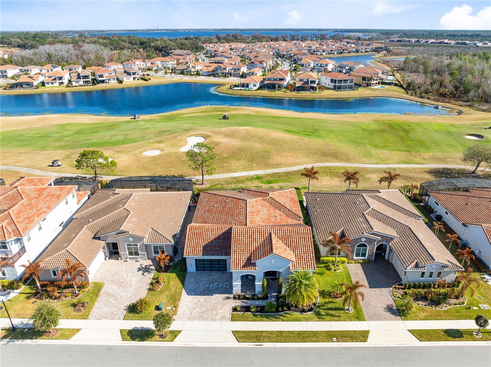 Under contract-accepting backup offers. Gated golf course living with panoramic water views in Eagle Creek. This impeccably upgraded four bedroom, four bath residence offers 3,170 square feet of refined living space and a three car garage with modern glass doors.Set along the Eagle Creek championship golf course, the home makes an immediate impression with manicured tropical landscaping, an extended driveway, and custom entry doors. Inside, a soaring foyer with a wood inlaid ceiling and statement chandelier sets the tone. Wide plank flooring, upgraded lighting, plantation shutters, and abundant natural light create a bright, elevated atmosphere throughout.Designed for both everyday living and entertaining, the layout offers formal and informal spaces including a formal dining room that flows seamlessly into the open living area. The living room features a custom TV wall and fireplace and opens directly to the screened lanai, blending indoor and outdoor living.The chef’s kitchen is a true centerpiece, showcasing premium cabinetry, waterfall edge designer countertops, a striking backsplash, stainless steel appliances, dual built in convection ovens, built in cooktop, solid wood pantry shelving, and a large center island with breakfast bar seating.Privately positioned at the rear of the home, the owner’s suite features a wall of windows overlooking the course and a coffered wood beamed ceiling for added architectural detail. The spa inspired bath includes an oversized super shower, split double vanities, and a private toilet room. The custom walk in closet offers extensive built in storage and a center dresser.Three additional bedrooms, including one en suite, plus a well appointed laundry room with sink and cabinetry complete the interior.Step outside to the screened lanai and take in sweeping golf and distant water views. The fully fenced yard offers space for pets and room to design your dream pool.Eagle Creek residents enjoy 24 hour manned gates and resort style amenities including a championship golf course, clubhouse, pools, tennis courts, fitness center, and a top rated elementary school within the community. Just minutes from Medical City, Nemours, Lake Nona dining and shopping, Orlando International Airport, and major highways for easy access to beaches and theme parks.Luxury, views, security, and location all in one exceptional home. Schedule your private showing today.