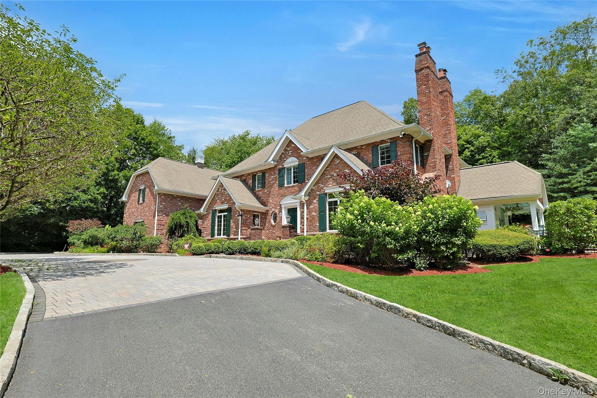 Welcome to this charming, brick Georgian colonial, set on 2 beautifully landscaped acres. Located near major highways and airport, the home is quiet and secluded, but still close to all wanted and needed amenities.  The personal resort feel, with a recently renovated heated, in-ground swimming pool, refurbished 3 par golf hole, and lush mature landscaping with its own walking trail, will have you feeling like you are on vacation 365 days out of the year! The kitchen has all new Thermador appliances (2025) featuring separate refrigerator and freezer, 2 built-in dishwashers, and a commercial grade range with double ovens.  The home features 9 heating/cooling zones all controlled by Smart thermostats, wi-fi controlled in-ground sprinkler system, additional 2 car detached garage with plenty of overhead storage, and full house generator.  This 4 bedroom home has plenty of space for a large family or lots of guests! It is perfect for entertaining year round - or just enjoying the peace and tranquility of the neighborhood.  All bedrooms are en-suite allowing for everyone to have their privacy. Picture yourself hosting holiday get togethers or quiet, intimate dinners.  The choice is ALL yours!