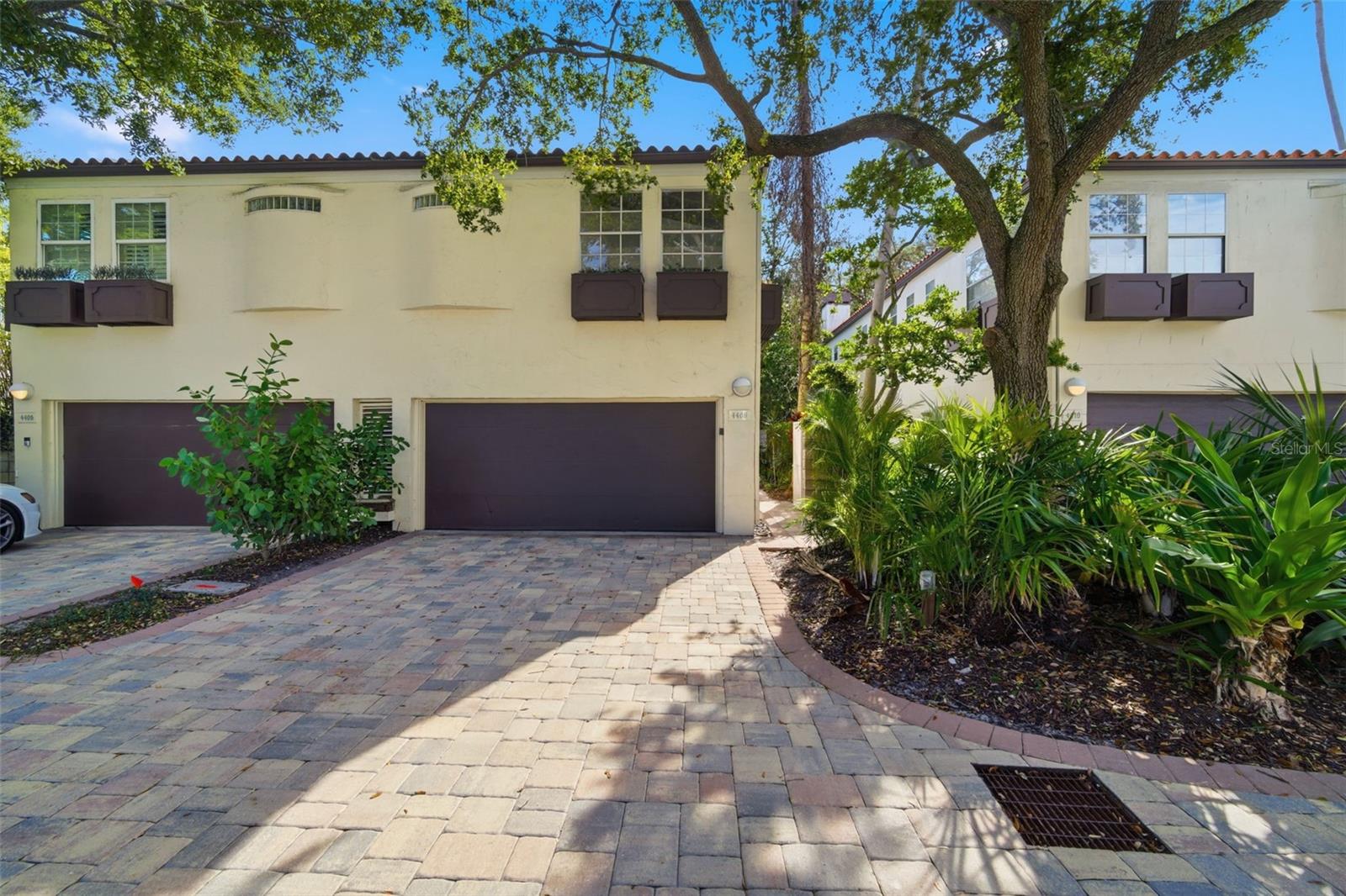 Discover the perfect blend of comfort and style at 4408 W Bay to Bay Blvd, a stunning townhouse located in the highly desirable South Tampa, Plant High School District, and Sunset Park neighborhood. With 3 bedrooms, 2.5 bathrooms, and 1,846 square feet, this home offers a bright, open design that feels spacious from the moment you walk in.Step inside to find soaring ceilings, elegant tile flooring, and large windows that fill the home with natural light. The main level features a generous living area that flows seamlessly into the dining space—ideal for both everyday living and entertaining guests. The kitchen is the true centerpiece, featuring sleek, modern appliances including a dishwasher, microwave, and electric range, along with ample cabinet and counter space so meal prep is effortless while still staying connected to the rest of the home.Upstairs, the primary suite provides a relaxing retreat with a large walk-in closet and a private en-suite bath. Two additional bedrooms are spacious with great closet space and convenient access to the second full bathroom. A half bath on the first floor adds extra convenience for guests.Enjoy Florida living at its best with a covered, screened-in porch overlooking your own private garden escape. Surrounded by lush landscaping and mature trees, this tranquil outdoor space is perfect for morning coffee, quiet evenings, or entertaining. French doors create an easy indoor-outdoor flow, making the space feel even more inviting.Additional features include a two-car attached garage with plenty of storage, central air conditioning for year-round comfort, and a cozy fireplace for cooler nights.Location is everything—and this one delivers. You’re just minutes from the Gandy Bridge Boat Ramp and the Tampa Bay waterfront, Bay Area Beaches, Downtown Tampa, Tampa International Airport, plus close to world-class golf courses, fine dining, shopping, major hospitals, University of Tampa, University of South Florida, and Busch Gardens. Sports and entertainment lovers will appreciate quick access to Tampa’s MLB, NFL, and NHL stadiums, which also host major concert events. And when you want a getaway, Disney World and Central Florida’s major theme parks are only a short drive away. Don’t miss your opportunity to own this Sunset Park gem—schedule your private tour today!