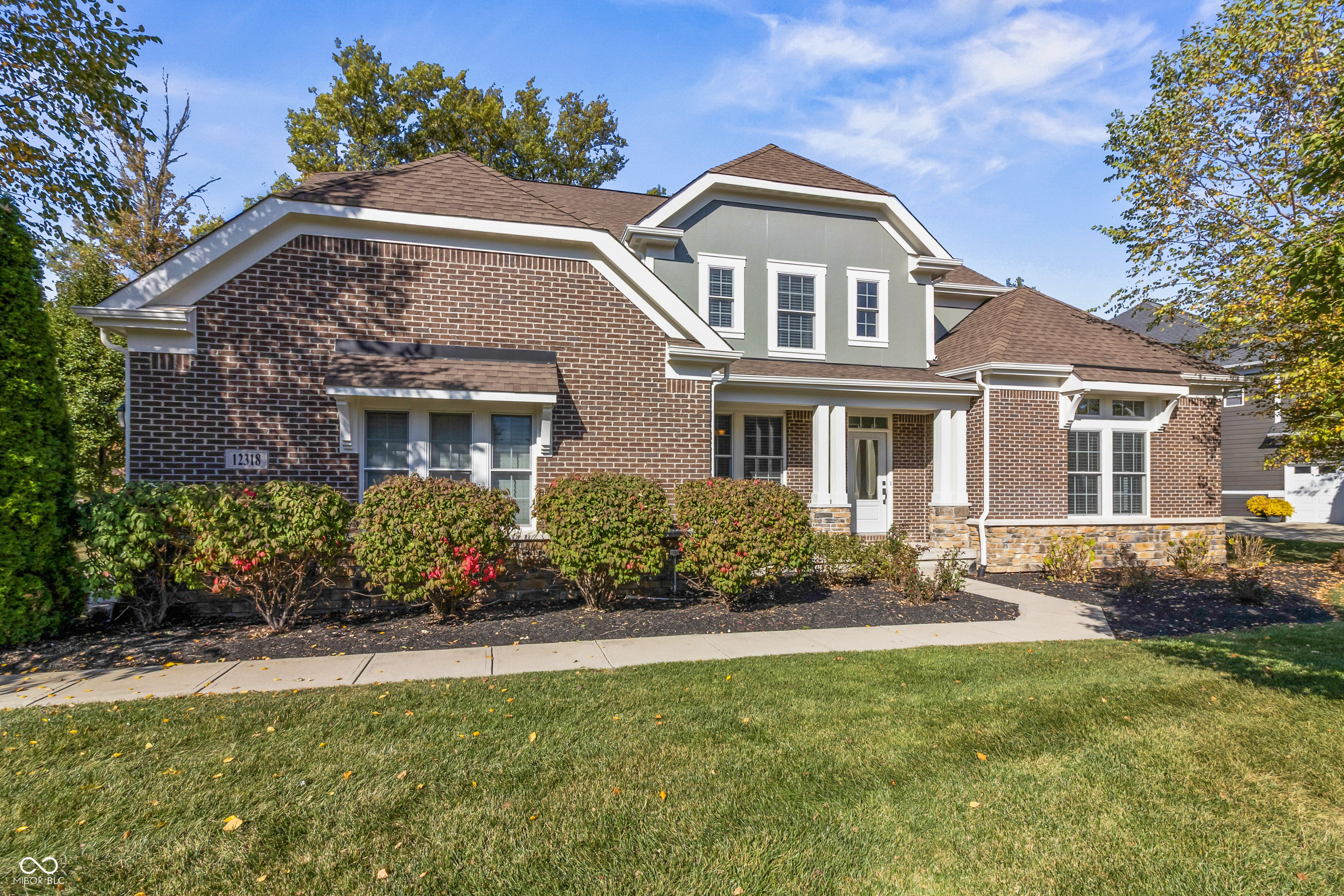 This stunning model home blends timeless elegance with luxurious upgrades! From the moment you step inside, you'll be captivated by the gleaming hardwood floors, impressive doorways, pristine moldings, and a dual staircase that makes a grand statement. Freshly painted inside and out and featuring all-new carpeting, this home feels brand new. The bright and airy gourmet kitchen boasts crisp two-toned cabinetry, a butler's pantry, and an open flow into the family room with a fireplace and built-in shelving. The finished basement-with an optional fifth bedroom (currently unfinished) and an existing full bathroom-also includes a wet bar and space for recreation and hobbies. Upstairs, retreat to the primary suite with its spacious step-up sitting room and spa-like bathroom featuring two separate walk-in closets with custom storage systems. Additional highlights include a designer lighting plan layout, plantation shutters in the breakfast room, a dedicated home office with glass doors, a mudroom with built-in storage, and a three-car finished garage. Enjoy outdoor living on the brand-new concrete patio, surrounded by mature trees and a fenced backyard. Both HVAC systems have received regular maintenance, and a new water heater was installed within the last two years. Located in desireable Thorpe Creek near the walking path, this corner-lot home combines luxury, comfort, and convenience in one perfect package. Welcome home!