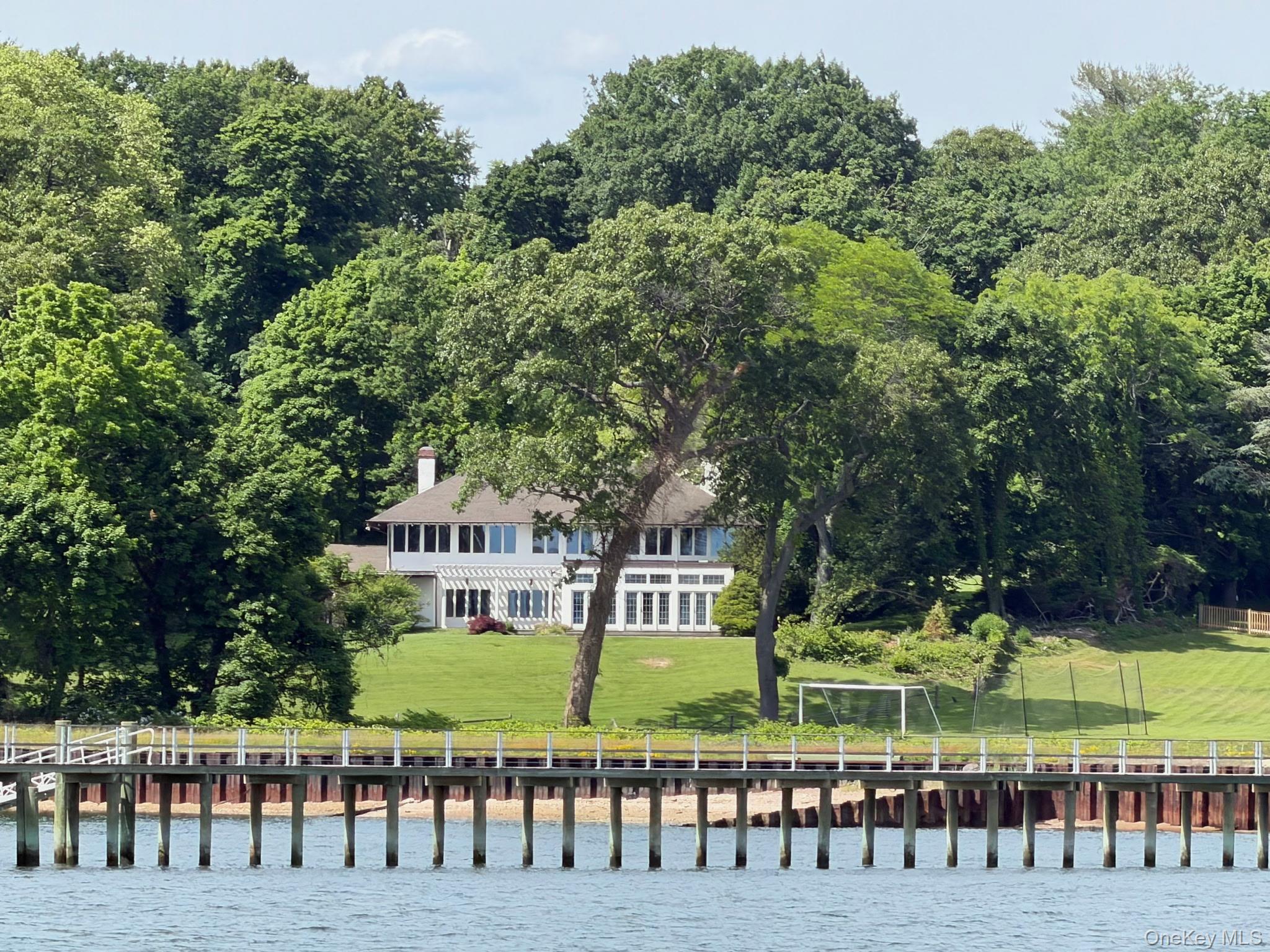 Built in 1924, this home was originally the carriage house to a former Gilded Age Gold Coast estate called Deephaven which occupied the entire cul-de-sac and was entered through the  wrought iron gates still in place today.  Sited to take advantage of expansive LI Sound and NY City skyline views.This is a rare opportunity to reimagine the existing structure or to build the home of your dreams.