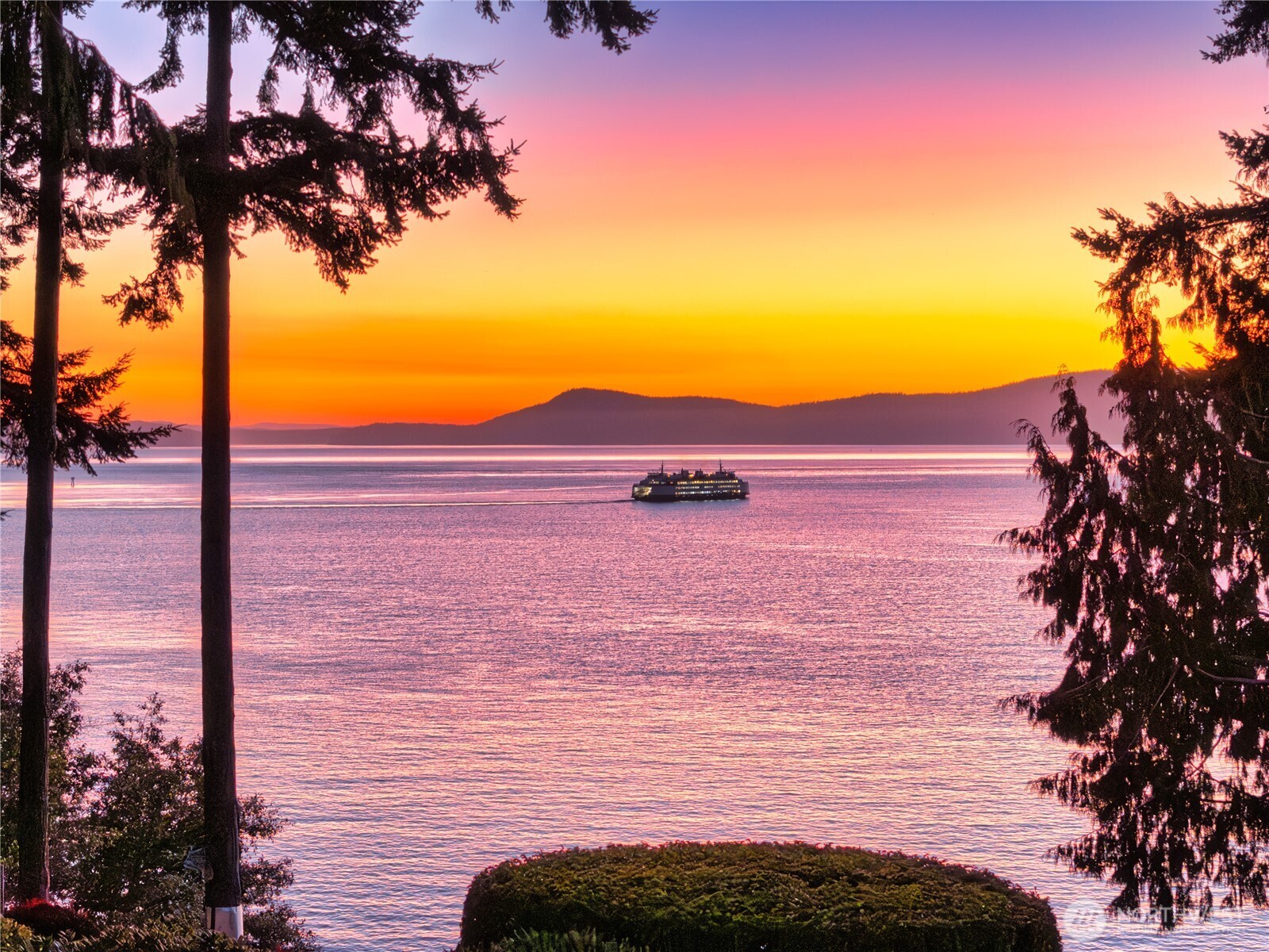 Luxurious 2-acre waterside estate with 220-degree view of 8 islands, Canadian Coast Mountains and ferries passing through stunning Thatcher Pass sunsets. Artistic uses of imported Italian stone custom surrounds for 8 gas fireplaces, reclaimed European Oak beams used for architectural accents and floor, and views from every room . Main level primary suite has spacious luxury bath with English copper soaking tub, solarium, fireplace, and reading area. Elevator to upper private office with balcony, or to the lower-level guests’ quarters, exercise room, sauna, media room, game room, wine storage, patios and hot tub.  Seven car heated garage with additional lower-level heated workshop. Extensive use of rare, tumbled travertine marble throughout.