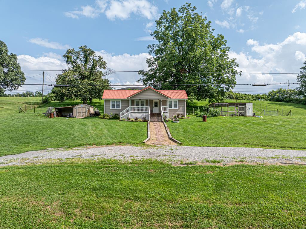 Peaceful Country Living on 2 Acres! If you've been dreaming of peaceful country living with room to spread out, this charming 3-bedroom, 1-bath ranch is ready to welcome you home. Situated on 2 beautiful acres with low county taxes, this property offers the perfect blend of comfort, convenience, and rural charm. Inside, you'll find new flooring and a spacious kitchen featuring newer appliances, an abundance of cabinet and countertop space, and a center island that's perfect for meal prep, entertaining, or gathering with family and friends. Step outside onto the large rear deck, where you can relax, grill, or simply enjoy the peaceful surroundings. The property also includes a utility building for extra storage and a chicken coop—and if you've ever wanted to start your own backyard flock, the chickens can stay with the new owners! As the day winds down, enjoy the nostalgic sound of the train gently clicking down the nearby tracks, adding to the property's quiet country atmosphere. Whether you're looking for your first home, a place to downsize, or simply a slower pace of life, this move-in-ready property offers endless possibilities with plenty of room to garden, play, or enjoy the outdoors.  Schedule your private showing today and see everything this charming country property has to offer!