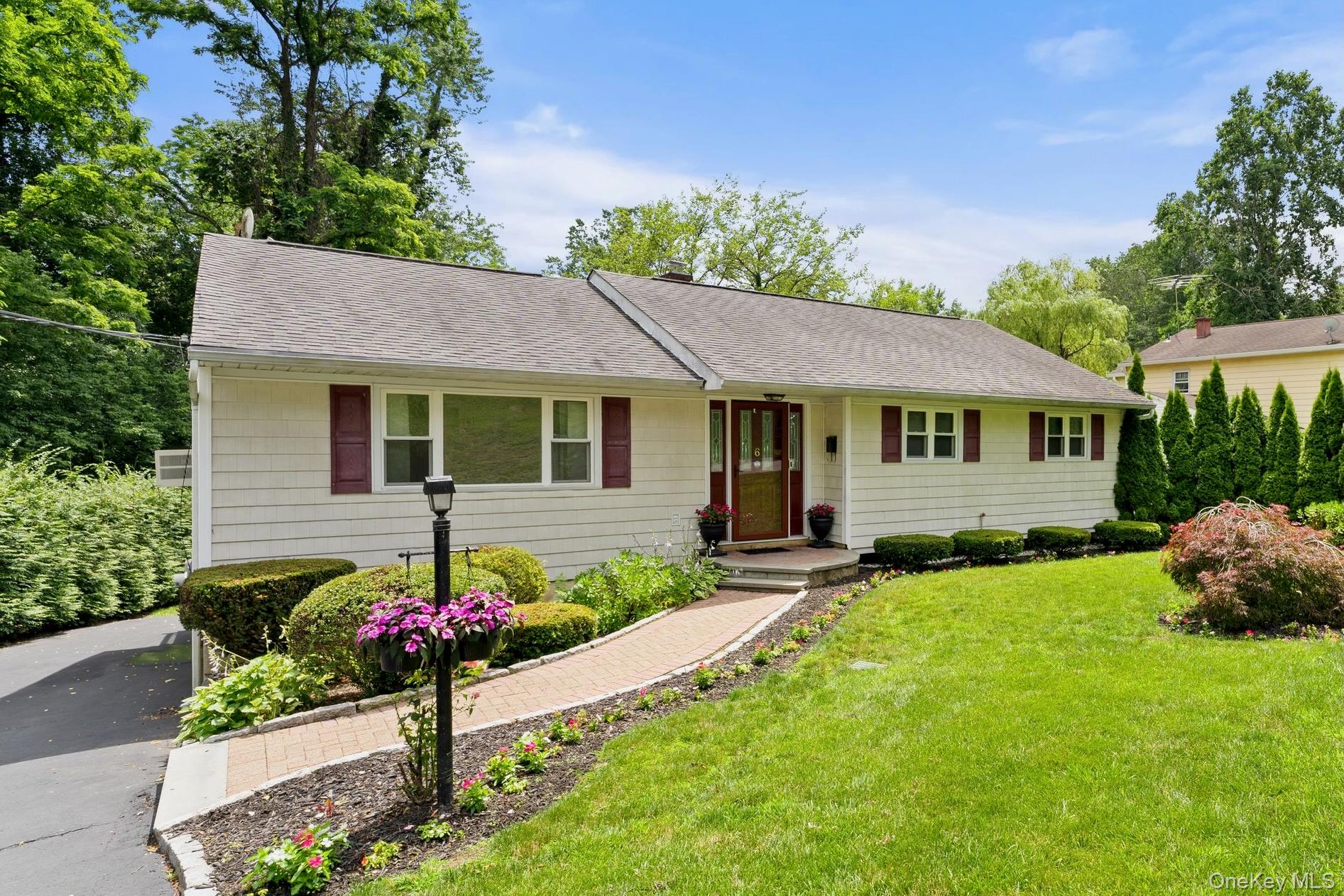 Welcome home to 6 Andover Road with great curb appeal and an oversized level lot. This lovingly maintained 3-bedroom, 2-bath ranch exemplifies pride of place. Ideally located on a quiet, tree-lined street in the College Corners section of Hartsdale, 6 Andover will win your heart. This sun-filled home offers the perfect blend of comfort, convenience, and one-level living—ideal for anyone seeking an easy lifestyle in a prime Westchester location. Step inside to a spacious and sun-filled living room, perfect for relaxing or entertaining. The seamless flow into the eat-in kitchen and formal dining room makes this home perfect for both everyday living and entertaining. From the dining room, sliding glass doors lead to a large outdoor deck, offering the ideal space for al fresco dining, hosting gatherings, or simply enjoying quiet moments year-round. The primary bedroom suite boasts an ensuite bath for added privacy, while two additional well-appointed bedrooms and a freshly updated full bath complete this level. The lower level offers a large rec room and laundry room, as well as additional space for a mudroom/office. The 2-car tandem garage and driveway provide plenty of parking. Outside, the large level backyard and expanside patio are perfect for relaxing, gardening, or entertaining. Just minutes from the Hartsdale Metro-North station, shopping, dining, parks, and major highways—this home truly has it all. Move right in and start enjoying the best of suburban Westchester living!