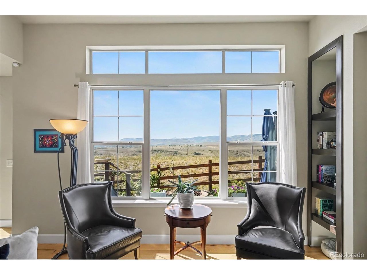 Wake up to incredible, unobstructed views of Table Mountain from a home that offers a rare sense of openness and privacy. With no homes interrupting the view, the setting feels peaceful and expansive, making it easy to forget you're living in a neighborhood at all. Inside, large windows, vaulted ceilings and an open floor plan fill the home with natural light while keeping those spectacular views front and center. Generous living spaces and spacious bedrooms provide plenty of room to spread out, while the beautiful stone fireplace creates a warm and inviting gathering place on cooler Colorado days.  The full basement adds even more flexibility with additional living and entertaining space, abundant storage and a wet bar. The oversized basement bedroom is especially impressive, nearly a second primary suite and ideal for guests, extended family or anyone looking for extra privacy.Outside is where this home truly shines. The meticulously maintained and beautifully landscaped backyard was designed to take full advantage of the incredible setting. Relax with your morning coffee, entertain friends, gather around the outdoor fire pit on cool evenings, or simply sit back and take in the sweeping Table Mountain views.  For added peace of mind, the property has already been properly fire mitigated and is along the plow route for those snowy days. Nearby access to trails, along with a neighborhood park and playground, makes it easy to enjoy the Colorado outdoor lifestyle right outside your door.Mountain views. Natural light. Flexible living space. A beautifully cared-for backyard. This is more than a home, it's a setting you'll want to enjoy every single day.