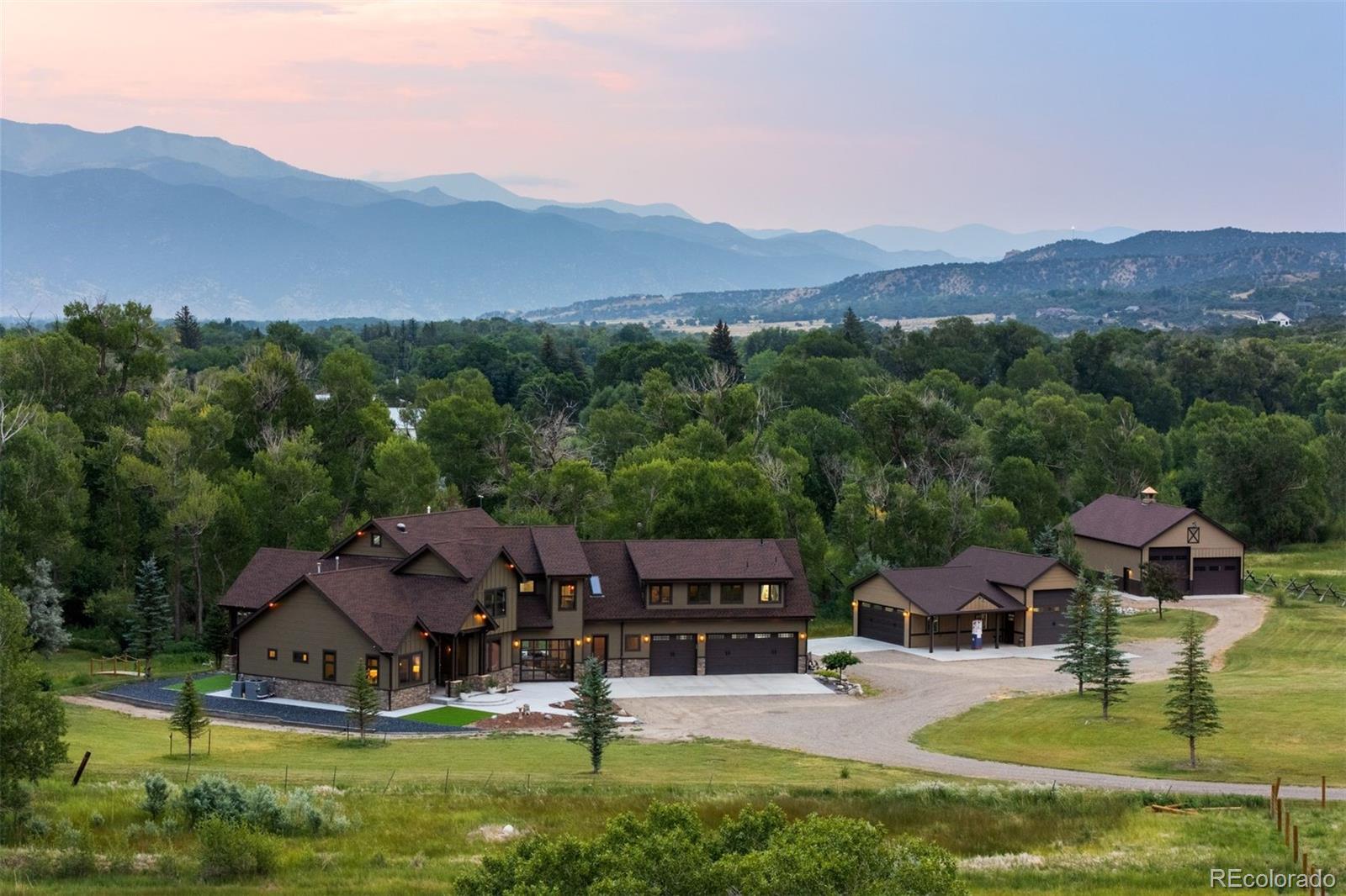 At River Springs Ranch, more than 1,100 feet of South Arkansas River frontage defines this rare sanctuary—where Aspen, Cottonwood, and Pine trees line the banks just outside your door. From every patio, deck and window, enjoy the sights and sounds of sparkling waters—ideal for fly fishing or simply relaxing. This 22-acre property includes an impressive riverfront home with an indoor-outdoor recreation room and separate one-bed/one-bath guest apartment, a detached workshop with RV parking, an equipment barn, an expansive spring-fed meadow, and a separate 2-acre parcel offering spectacular views of Mount Shavano & Mount Ouray—all just 10 min. from downtown Salida and 25 min. from Monarch Ski Area. 

Completed in 2024 and designed to mirror the river’s flowing contours, the sprawling mountain-contemporary home blends seamlessly with the landscape. The great room features 16-foot vaulted ceilings, a wood pellet stove, and a sliding door that opens to a riverfront patio. The spacious, well-appointed kitchen is built for cooking and entertaining. In the primary suite, wood floors, unique lighting, and panoramic mountain views create a retreat, complete with a clawfoot tub, large marble shower, and generous closet space. The indoor-outdoor recreation room adds hosting flexibility, with front-and-back glass garage doors that open fully to the outdoors, finished with corrugated steel accents and custom lighting. 

Above the attached 3-car garage, a fully equipped apartment offers space for guests, family, or rental income. A detached workshop and equipment barn provide all the storage you could need, including room to stow your RV or other large gear. A second parcel includes two RV hookups with water and sewer access. A large portion of the land is protected by a Colorado Conservancy Easement - no public access allowed - ensuring the property’s pristine beauty remains untouched. Come experience unmatched Colorado tranquility, where river & mountain lifestyles converge.