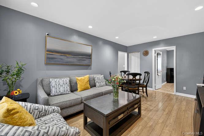 Ideally positioned in the heart of Deepdale Gardens, this first-floor residence is set within a coveted Blue Ribbon School District (K–8) and offers effortless access to shopping, dining, and transportation. Encompassing approximately 1,000 square feet, the home features a refined and flexible two- to three-bedroom layout complemented by one full bathroom, offering both comfort and versatility in a premier setting. Southern and northern exposures provide excellent natural light throughout the day. The community offers green spaces with designated areas ideal for growing vegetables and herbs. HOA fees include electricity, heat, gas, water, cooling, sewer, trash collection, common area and grounds care. Interior highlights include hardwood floors throughout, solid wood cabinetry, quartz countertops, a well-appointed kitchen with high-end stainless steel appliances and tile backsplash, in-unit washer and dryer, recessed lighting, and wall and window A/C. Two dedicated parking stickers included, with garage rental options available.  24-hour security. Community amenities include a playground and mini waterpark. No transfer tax. Cat-friendly.