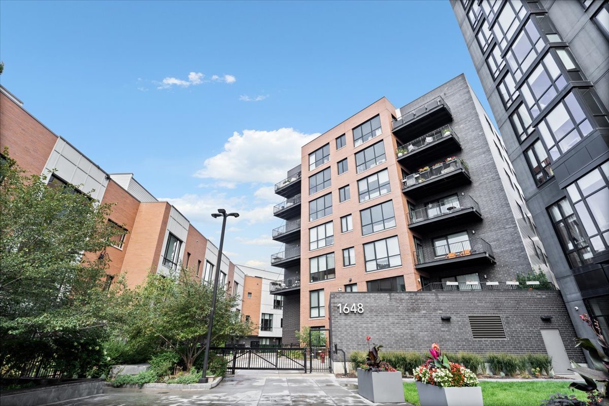 Set within Alcove, a boutique all-brick elevator building tucked behind a private courtyard, this luxurious 4-bedroom, 3.5-bath home offers the perfect blend of vibrant city living and serene privacy. Just steps from the Blue Line, acclaimed restaurants and shopping, this spacious 2,365-SF corner unit features a large private balcony and access to a common rooftop deck with skyline views. Every detail of this home has been elevated with thoughtful, high-end customizations. A stunning fluted marble dry bar framed by a custom archway serves as a show-stopping centerpiece, while composite decking transforms the private balcony into a polished outdoor retreat. Inside, bespoke living room built-ins, designer lighting, and custom window treatments throughout. The chef's kitchen boasts Viking stainless steel appliances, Italian cabinetry, and quartz countertops, seamlessly connecting to the expansive open concept living and dining areas. Primary suite with two closets, large ensuite bathroom with free standing soaking tub. Additional guest suite with ensuite bathroom and walk-in closet. Two additional large bedrooms with custom chair rail molding and third full bath. All closets finished with custom buildouts. Additional highlights include wide-plank wood flooring, large, fully organized, walk-in pantry, smart home capabilities, and a fully finished laundry room with built-in cabinetry and folding counter. This residence isn't just move-in ready, it's meticulously designed for the way you live, offering unmatched comfort, style, and location in one of Chicago's most sought-after neighborhoods. Garage parking and addl' storage included.