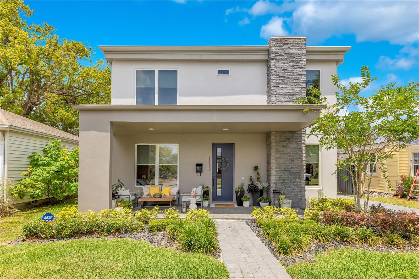 This 5-bedroom, 3-bathroom pool home hits a rare balance—modern construction with thoughtful design, tucked into one of College Park’s most walkable pockets. From the street, it stands out for all the right reasons. Sharp exterior, clean lines, and a wide front porch framed by brick pavers making it the kind of spot where neighbors slow down to say hi. Step inside and the layout makes sense right away. Gorgeous hardwood floors run throughout the shared spaces in the home, connecting the front flex room, kitchen, and living area in a way that feels open but still gives each space its own identity. The flex room makes an ideal office, sitting area, or second hangout spot—whatever fits your routine. Just across from it, there’s a main-floor bedroom with its own full bathroom, making it a solid option for guests or multigenerational living. The kitchen opens up to the main living area with plenty of counter space, clean finishes, and room to move while overlooking the living room that’s anchored by a custom fireplace wall—it’s the kind of setup that keeps everyone connected. Whether you’re prepping dinner, hosting friends, or catching up after a long day, you’re always part of the conversation. Upstairs, the bedrooms are spaced out just enough to keep things comfortable and fitted with soft, high-end carpet. The primary suite offers plenty of breathing room, with a spacious ensuite featuring double sinks and a walk-in shower, plus an expansive walk-in closet that actually fits your whole wardrobe without feeling cramped. The remaining bedrooms are well-sized and share access to a full hall bath. Out back, you’ve got a setup made for easy weekends. The covered lanai has a built-in grill station and space to kick back with a drink or catch a game on the wall-mounted TV. Beyond that, the pool is the kind you actually want to use—long enough to swim laps, shallow sun shelf for lounging, and surrounded by low-maintenance turf that keeps things looking sharp. The detached garage sits at the rear, keeping the yard open and useful. There’s even a private lounge area at the back of the yard, all tucked behind a tall fence for added privacy. And the location really does hit the sweet spot, especially with no HOA and tucked into a quiet street, just blocks from Edgewater’s shops, restaurants, and all the neighborhood favorites, with easy access to downtown when you need it. This is the kind of home that feels dialed in from the start—plenty of room, thoughtful design, and a location that makes life simple.