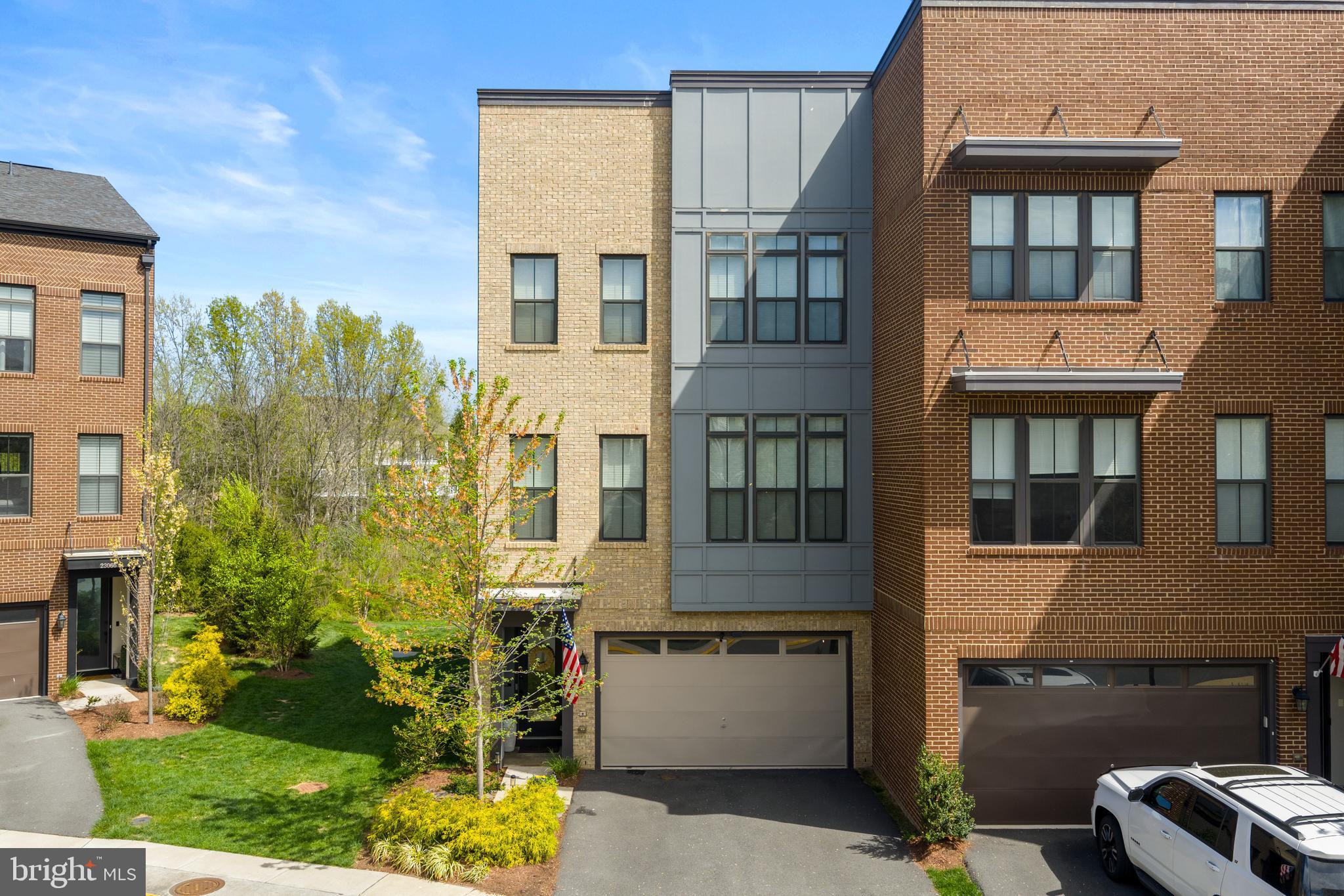 Welcome to this beautifully appointed end-unit townhome, centrally located in Brambleton with a rare water view. This home has been the backdrop for years of wonderful memories, offering 2921 square feet of thoughtfully designed living space, including 3 bedrooms and 4 bathrooms (2 full and 2 half.)As you walk up, you’ll immediately appreciate the modern three-level design. Step through the bright foyer filled with natural light and take in the gorgeous hardwood floors. This level features a convenient half bath, a mudroom designed for a busy lifestyle, and a spacious recreation room with built-in cabinetry and endless possibilities.Continue to the main level - the true hub of the home - where you’ll find a stunning, modern kitchen designed for both everyday living and entertaining. Highlights include an oversized leathered marble island, high-end stainless steel appliances, a gas oven, and a cooktop with a hood. There’s space for a large dining table, along with a living area with gas fireplace and custom built-ins that opens to a maintenance-free deck. Step outside and take in the peaceful wooded, water view - one of the home’s most special features. A stylish half bath completes this level.Upstairs, the primary suite offers a private retreat with a spacious layout, walk-in closet, and a beautiful ensuite bathroom featuring a walk-in shower and two vanities. Two additional generously sized bedrooms, a full hall bath, and a convenient upper-level laundry room provide both comfort and functionality.Additional highlights include a front-facing two-car garage and a private fenced backyard with a paver patio, perfect for relaxing or entertaining.Located in the highly sought-after Brambleton community, residents enjoy an exceptional lifestyle with access to pools, fitness centers, tennis and basketball courts, playgrounds, scenic walking and biking trails, and a vibrant community center with year-round events. Everyday conveniences - including shopping, dining, and personal services - are just moments away, along with the added benefit of high-speed internet included in the HOA. Zoned for Madison’s Trust Elementary, Brambleton Middle, and Independence High School, this home offers access to some of the area’s most desirable schools.This is Brambleton living at its finest - where community, convenience, and comfort come together seamlessly. Make this YOUR home! Interior photos will be posted soon. :)