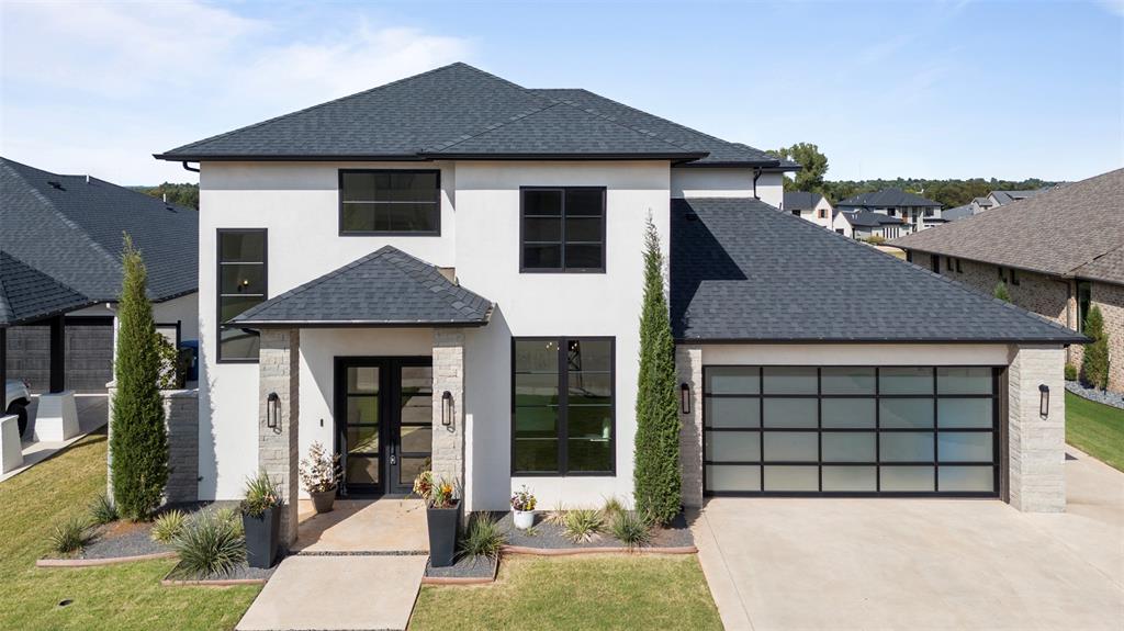 Luxury living in one of Edmond’s premier gated communities. Upon entering, this stunning home features grand double iron doors, natural wood floors, and a private office with nearby half bath. The chef’s kitchen boasts GE Monogram appliances, quartz countertops, soft-close cabinetry, large pantry, and oversized built-in fridge. A wet bar with an ice maker and wine fridge makes entertaining effortless in the dining area. Soaring ceilings with natural light and large windows allow for easy flow in the open-concept layout. The living room opens to a covered patio with fireplace and fenced yard—perfect for indoor/outdoor living. The main-level primary suite includes a soaking tub, dual shower heads, double vanities, and a walk-in closet with direct laundry room access. Upstairs offers a spacious game room, open flex area, and two bedrooms with a dual-sink bath. The oversized two-car garage has space for a golf cart with its own private entry. Close to top-rated Edmond schools, dining, and optional country club amenities, you won’t want to miss the opportunity to see this beautiful property. 
Schedule your showing today!