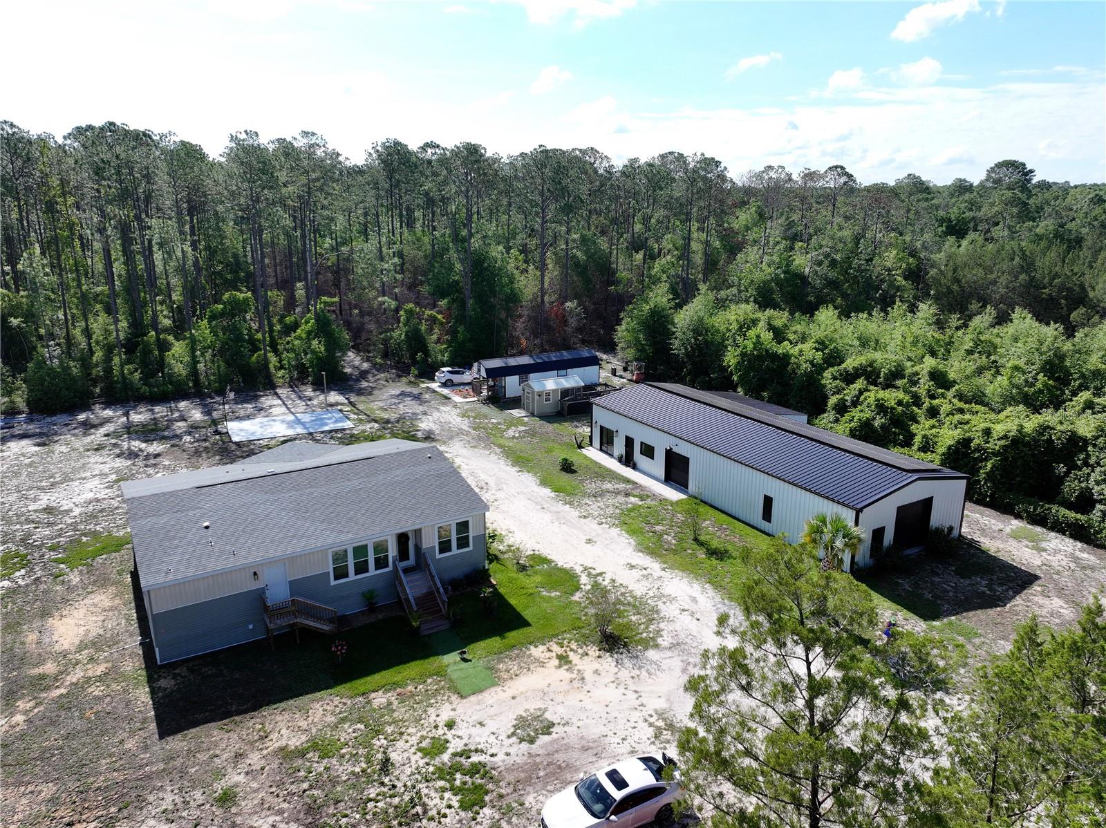 Private 5-Acre Mini Ranch with Upgraded 2022 Mobile Home & Massive Barndominium – Prime Hernando County LocationEscape to the perfect blend of country living and modern convenience with this exceptional 5-acre property in Hernando County, Florida. Just minutes from the Suncoast Parkway exit on Cortez Blvd, this private and fully fenced property offers an easy commute to Tampa and Citrus County while keeping you close to shopping, dining, and everyday amenities.The beautifully upgraded 2022-built 4-bedroom, 3-bath mobile home was originally a model home and showcases premium finishes and thoughtful upgrades throughout. Spacious, modern, and move-in ready, the home offers comfortable living with plenty of room for family, guests, or a home office setup.A standout feature of the property is the impressive 2,400 sq ft barndominium, including approximately 900 sq ft of finished living space and an expansive workshop/storage area perfect for: • Working on cars or equipment • Boat or RV storage • Farm and ranch operations • Hobby space or small business useThe land is fully fenced and cross-fenced, making it ideal for: • Horses • Cattle • Goats and other livestock • Agricultural pursuits or hobby farmingAdditional property highlights include: • Fenced dog kennel area with two separate dog houses • Private setting with plenty of open space • Room for trailers, toys, and equipment • Ideal setup for animal lovers and outdoor enthusiastsEnjoy the convenience of nearby shopping and restaurants along Cortez Blvd, including Marshalls, Belk, Petco, Dick’s Sporting Goods, Hobby Lobby, Bonefish Grill, Olive Garden, Carrabba’s, Mission BBQ, and Cheddar’s — all just a short drive away.This unique property offers the rare opportunity to enjoy peaceful country living without sacrificing access to major roads, shopping, dining, and city conveniences.Bring your animals, your hobbies, and your vision — this one-of-a-kind property is ready for it all.