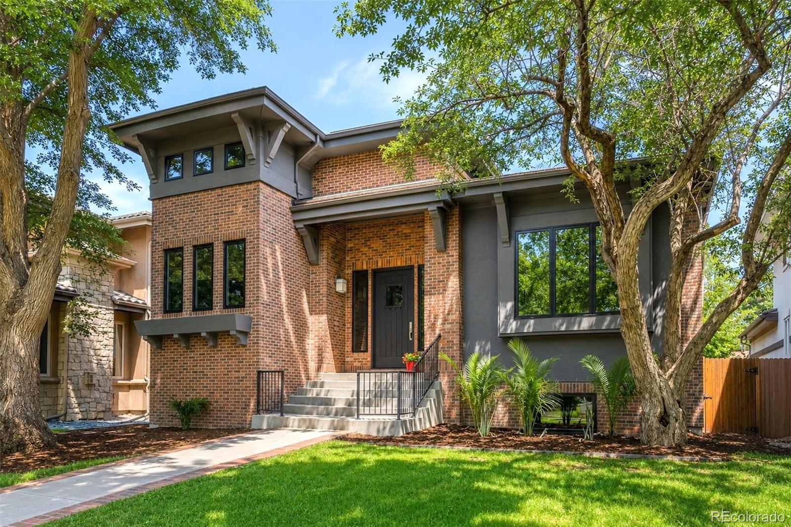 Set on a quiet, tree-lined street just steps from Observatory Park, this custom residence offers soaring ceilings, abundant natural light, and a flowing floor plan designed for both everyday living and gracious entertaining. The kitchen opens seamlessly to the main gathering space, where the day's activities naturally unfold. The main-floor primary suite is a true retreat, featuring a spa-inspired bath, dual walk-in closets, and direct access to the outdoor living areas. A main-floor office or bedroom adds flexibility for working from home, hosting guests, or multigenerational living. The walkout lower level provides a second destination for entertaining, complete with a spacious family room, dual-sided fireplace, wet bar, and wine storage, along with generous space for family and guests. Set on a larger lot than most in the neighborhood, multiple patios and mature landscaping create peaceful outdoor living spaces that extend the home's footprint well beyond its walls. A rare three-car garage, difficult to find in Observatory Park, provides additional flexibility for vehicles, storage, or hobbies. Timeless architecture and thoughtful craftsmanship make this a home where every space is both purposeful and inviting.