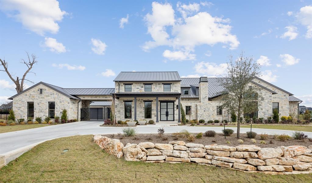 Set on an oversized 1+ acre lot, this custom Texas Hill Country inspired estate blends timeless design with elevated modern living. Standing seam metal roof, gas lanterns, beamed ceilings, abundance of quartzite counters, and white oak flooring create a warm yet sophisticated atmosphere.Designed for entertaining, the home features a temp. controlled dramatic glass wine display, formal dining, and a chef’s kitchen with Wolf cooktop, double ovens, 36” paneled fridge and freezer, & built in Wolf coffee maker. A fully equipped prep kitchen with double ovens, 2 dishwashers, and an oversized dream pantry makes hosting effortless. Game room with bar opens to a courtyard fireplace, while the outdoor living spaces include a Coyote grill, covered patios with fireplaces, and a resort style pool with hot tub and waterfall.All five bedrooms are ensuite, including two guest suites with courtyard views. The private primary retreat offers dual vanities, two walk in closets, 2nd utility area for full size stackable WD units, electric shade pre wire. Additional spaces include a private office, home gym, built-in desks, media rm., and a spacious laundry room with dog shower and ironing center.Smart-home equipped with Lutron controls and surrounded by expansive grounds, this exceptional residence offers luxury, privacy, and elegance at every turn.