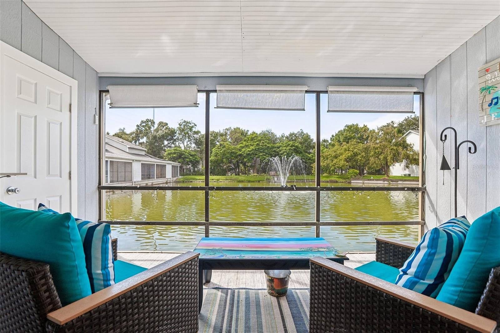 Downtown Dunedin? Yes, please! Overlooking a tranquil pond and fountain where ducks gather daily, the home has undergone extensive, top-to-bottom capital improvements and designer renovations, leaving nothing for a new owner to do. Step through the front storm door—equipped with an integrated pull-down screen—into a bright main level that Team Farrell of NPR completely transformed in 2025. Soaring volume ceilings and wide sliding glass doors fill the open living and dining spaces with natural light, highlighted by new luxury vinyl plank (LVP) flooring, fresh drywall, crisp baseboards, and freshly replaced interior, exterior, and closet doors. Across the dining room, entertaining is effortless thanks to a custom coffee and wine bar featuring dedicated utility drawers and a built-in wine rack. The kitchen is a standout culinary space, showcasing cabinetry designed by Jeff Daly Designs & Mfg with convenient pull-out drawers, an illuminated glass-front display cabinet, and lower cabinetry updated in 2025. Natural stone countertops by Plaza Stone are paired with a designer tile backsplash, a modern sink and faucet, upgraded lighting, a custom architectural shiplap ceiling, and a full suite of brand-new 2025 appliances. Just outside, the screened lanai—re-screened and fully renovated in June 2025—features high-quality indoor/outdoor carpeting, a replaced storage door with new trim, and built-in shelving, creating the perfect private retreat for morning coffee or evening wine by the water. The main-floor layout also provides exceptional functionality with a private guest bedroom offering its own direct access to the full downstairs bathroom. This bath has been extensively updated with a custom shiplap ceiling, designer lighting, a new vanity, a medicine cabinet, a toilet, an updated closet door, and a bathtub enclosed by sliding glass doors. Cleverly tucked beneath the stairs is a dedicated utility and laundry closet featuring updated flooring, built-in storage shelves, a newly installed water heater, and a full-size washer and dryer. Plush carpet installed in 2025 leads upstairs to a sun-drenched loft with a skylight, offering a versatile space for a dedicated home office, creative studio, or quiet reading nook. Down the hall sits the expansive primary retreat, completely remodeled by CMK Construction with easy-maintenance tile flooring that carries through into the private ensuite bathroom. The primary bath is finished with a custom-tiled walk-in shower, modern vanity, updated toilet, designer fixtures, and matching shiplap ceiling detailing. Beyond the visible upgrades, the home boasts substantial infrastructure enhancements for safety and energy efficiency. The property is fortified with Ameritech hurricane impact windows installed in 2020 and attic insulation completed by Gulfside Insulation in 2021. Electrical safety is ensured by a 125-amp service panel with whole-home surge protection and six updated GFCI outlets installed by Palm Harbor & Dunedin Electric. Year-round comfort is delivered by a central air conditioning system installed by Advanced Cooling Systems, preserved through biannual professional servicing and cleaning by Harrison Hardy alongside routine filter changes every two to three months. The location is unbeatable: you are less than a mile from downtown Dunedin’s award-winning craft breweries, artisanal eateries, boutique shops, and lively community festivals, and just minutes away from world-renowned Gulf beaches.