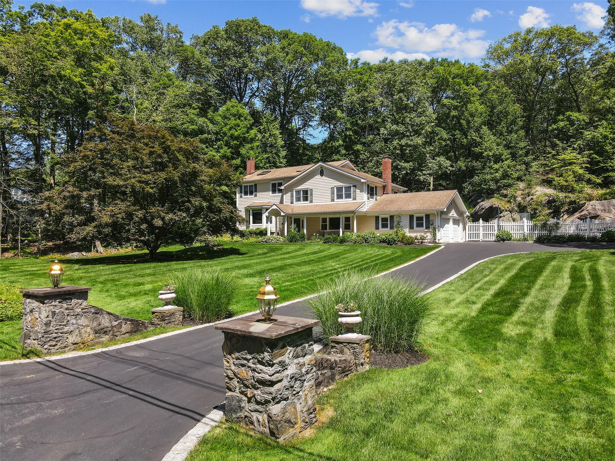 Windmill Farms expanded and updated five-bedroom split level home with beautiful private property.  Bright and spacious home with wood floors, abundant windows and wonderful backyard with sport court. The main level includes an oversized family room with fireplace, built in shelves and a door to the patio, a laundry room and full bathroom. Up a small flight of stairs to the eat in kitchen with stainless appliances and a living room that is open to the dining room and has doors to the deck. Upstairs is the primary suite with walk in closet and a newly renovated attractive bathroom, two additional bedrooms and a hall Bathroom. Up another half flight of stairs to two additional bedrooms and an office nook/ sitting area. The lower level offers plenty of storage and the utility room. The outdoor spaces feature a very private and quiet yard, a trex deck, a blue stone patio and an expansive sport court that has endless possibilities. The home is located on a quiet street in Windmill Farms. This highly desirable community offers owners the exclusive opportunity to join the beloved private lake club and enjoy the beach, tennis, pickleball, boating, swimming, dining and so much more. Full house generator. Byram Hills School
