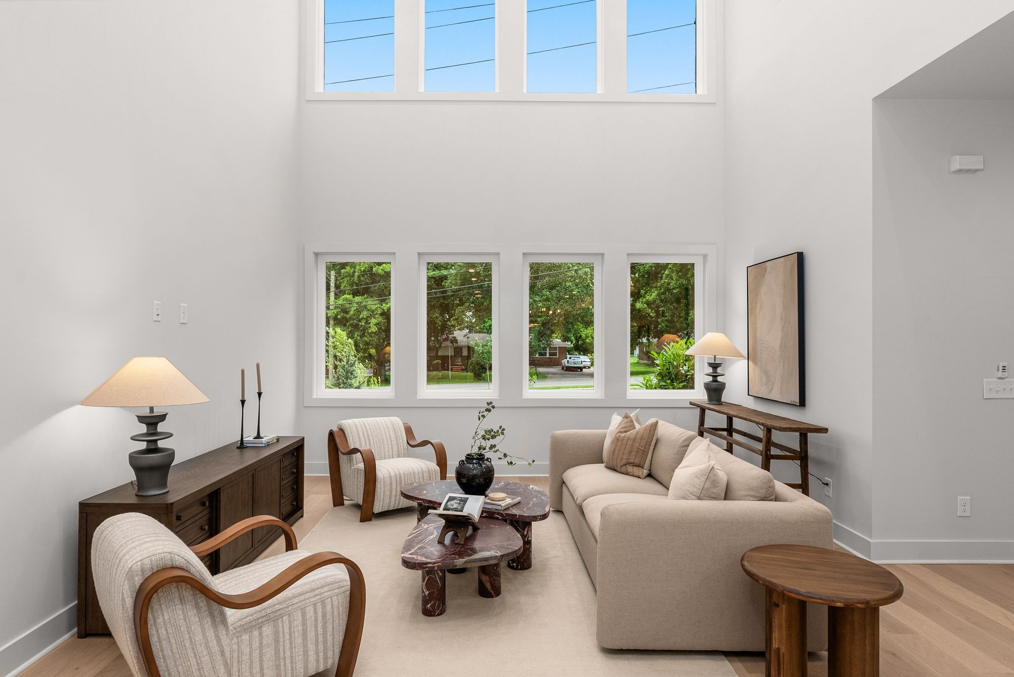 Welcome to Eastland Row, a thoughtful 10-home community in the heart of beloved East Nashville! This 3,200+ SF home features 4 bedrooms, 4 full baths, and 2 half baths, showcasing a thoughtfully designed layout and high-end finishes throughout.  A unique feature of this home is the private flex space located off the two-car garage, offering endless possibilities. This versatile space includes a kitchenette and loft area, ideal for a home office, studio, or guest suite.  From the moment you enter, expansive windows and soaring ceilings draw you in, filling the living spaces with natural light and an open, airy feel throughout. Notable highlights include a beautifully designed kitchen featuring a wood-trimmed ceiling and upscale lighting, flowing seamlessly into the living areas. Additional touches include stylish wallpaper, organic tiles, and well-designed drop zone. Step outside to a private backyard and covered porch — perfect for relaxing or entertaining.  With meticulous attention to detail, this home provides modern living with flexibility and ease. Don’t miss your chance to own in Eastland Row!