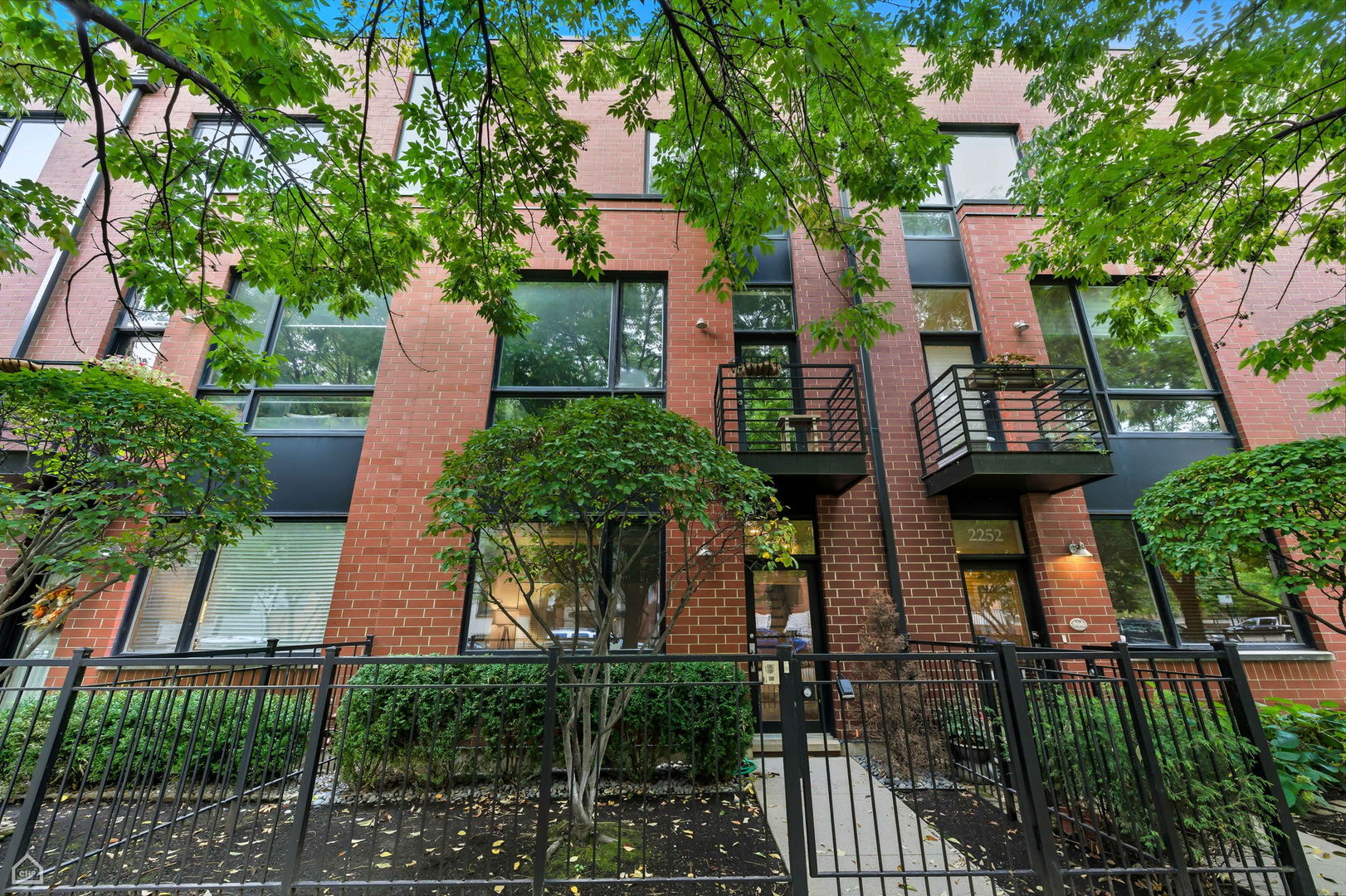 Perfectly positioned by the river and close to Lincoln Park and Bucktown this 3-story townhome offers the best of city living in a tranquil riverfront community! Flooded with natural light from its desirable northeast and southern exposure, this home feels open and inviting at every turn. The entry level welcomes you with elegant stone flooring and a versatile open flex space that can easily serve as a guest bedroom, fitness room, media lounge or office. This level also includes your entrance to a spacious and private two-car garage, making it extremely convenient to carry in groceries from the Costco located down the street.  As you walk up to the main floor, you're invited by rich dark hardwood floors and tall ceilings, that set a warm and elevated tone. The kitchen is beautifully updated with white cabinetry, stainless steel appliances and striking Calacatta Nuvo beige quartz countertops and kitchen island. A thoughtfully placed half bath also enhances the flow of the space, making entertaining effortless and comfortable. The living room centers around a beautiful gas log fireplace, creating a cozy yet elegant focal point. Just off the living area, a dedicated dining room provides the perfect setting for gatherings and dinner parties while maintaining the openness of the home's modern floorplan. Multiple outdoor spaces create a natural extension of the living areas. A front balcony off the living room brings in abundant light and fresh air, while a second balcony off the kitchen is perfect for enjoying your morning coffee and also the perfect spot to set up your grill.  The upper level features two generously sized bedrooms, including a luxurious primary suite with a large walk-in closet that has built-in shelving and a spa-like ensuite bathroom complete with a double vanity, soaking tub and separate standing shower. A linen closet and side-by-side laundry are conveniently located in the hallway that separates the two bedrooms. The top floor is a true extension of the home's living space that can be transformed to fit your lifestyle. Whether it's a serene home office, an inspiring creative nook or a cozy lounge, this space invites you to design it your way while enjoying immediate access to the rooftop terrace.  Nestled near the water and moments from Elston Ave., Clybourn Ave., and Diversey Pkwy, you'll enjoy easy access to shops, cafes and everyday conveniences all while tucked away in a smaller, more private neighborhood setting.