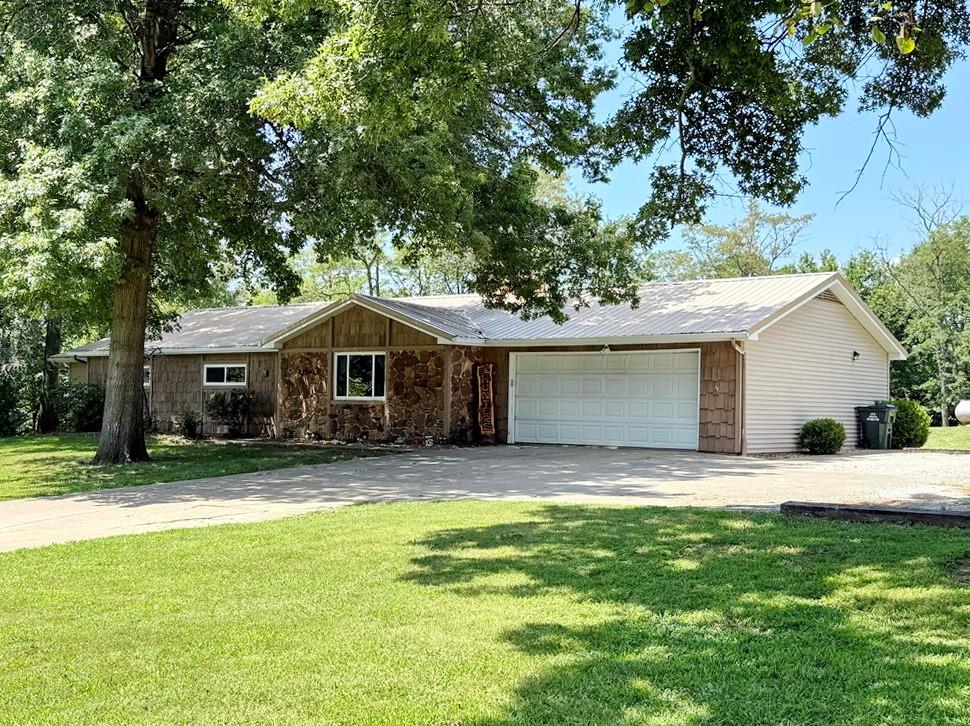 Spacious & Functional Country Home with Pool & Acreage Just Outside El Dorado Springs, MO. 
Enjoy peaceful country living just minutes from town in this beautifully maintained 4-bed, 3-bath ranch-style home on 2.81 scenic acres. Located less than 2 miles from El Dorado Springs on a paved road, this 2,221 sq ft one-level home features mature shade trees, open yard space, and a spacious layout perfect for both daily living & entertaining. Inside, you'll find two large living areas, a generously sized kitchen with pantry storage, and lots of bedroom & bathroom space. The vaulted ceiling & fireplace in the living room are complemented by built-in cabinetry and luxury vinyl plank flooring providing a spacious yet inviting retreat for yourself or guests.  All four of the bedrooms are nice-sized & 2 of the bedrooms have en-suite bathrooms. The primary bedroom suite features a large walk-in closet, a powder room, large bathroom, & private access to the patio & pool.  Recent upgrades include a new dishwasher, newer stove, new LVP flooring, upgraded lighting, & 2 water heaters (1 being tankless.) The second living area opens out to your own private retreat: a 17' x 33' in-ground pool (4' to 8' depth) with privacy fencing & newer mechanicals, plus a covered patio & nice pool deck ideal for outdoor dining or relaxing. The owners have been busy getting ready for a move so they didn’t open the pool this summer- but they loved the pool in years past. The property also includes an attached 2-car garage with extra storage, an outbuilding, RV pad with 50 AMP hookup, newer septic laterals, & abundant off-street parking. Located outside city limits for more flexibility and frequent wildlife sightings, this home blends country charm with modern convenience. El Dorado Springs offers schools, shopping, dining, and healthcare, plus easy access to lakes and day trips to Kansas City, Springfield, Joplin, or Branson. Don’t miss this move-in ready gem!