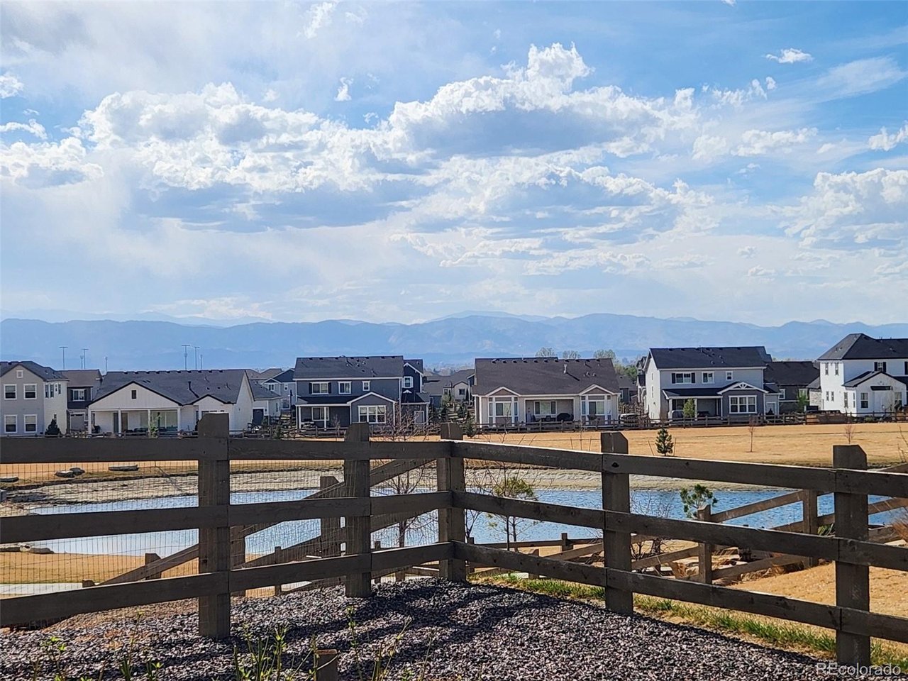 A rare opportunity to own a walkout ranch with sweeping mountain and water views, set on a private cul-de-sac backing to open space. Thoughtfully updated home with five bedrooms, four baths, flex room and spacious living areas will offer the flexibility you need to enjoy this home to it's fullest. Enjoy easy back gate access for fishing at the pond, playing soccer in the open area, and relaxing and enjoying the outdoor space and amazing views this home provides. Watching the sunset from your spacious deck is a great way to end your day before retiring to the primary suite with five piece upgraded bath including fully tiled shower, large soaking tub and walk-in closet. Split bedroom plan offers two additional bedrooms plus a flex room suitable for an office, exercise room, craft room or reading room - so many options all on the main floor! Main level laundry and guest half bath mean you can just enjoy the upstairs and live solely on the main floor if you'd like! The fully finished walk-out basement works so well for entertaining with a wet bar including beverage refrigerator and space for game tables as well as a spacious seating area to watch your favorite team or that special movie. Direct access to the back patio enables you to expand your living experience into the outdoors for even more space and more mountain views. Your guests or extended family will love having their own private area with two basement bedrooms and 3/4 bath plus second laundry with stacked washer and dryer that are included with this home. Two ovens, gas cooktop, microwave, kitchen refrigerator and large pantry make your life so much easier when preparing food. Custom touches include slated wall in the great room and modern fireplace, updated lighting, movement sensor for under cabinet lighting, plus gas stub for firepit on the deck, wood flooring, tankless water heater, humidifier, neutral colors and abundant natural light make this home a winner you won't want to miss!