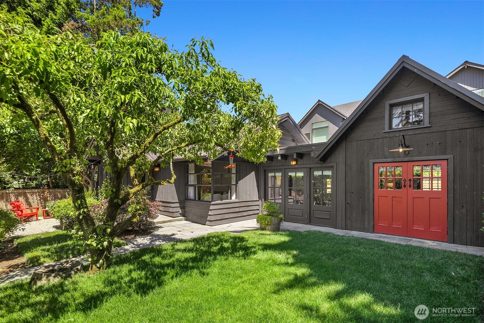 Some homes have a personality all their own. This captivating Madison Park cottage is one of them. Tucked on a quiet street facing the lush greens of the 15th hole at Broadmoor Golf Course, it delivers the kind of charm that simply cannot be manufactured — warm, characterful & utterly inviting from the moment you arrive. Inside, a welcoming living room anchored by a wood-burning fireplace sets the tone beautifully. The kitchen features stainless steel appliances & opens naturally into a rustic chic farmhouse-style dining room that feels equally at home hosting a dinner party or a quiet weeknight meal. Doors on either side of the main living area create effortless indoor-outdoor flow, connecting the front yard & a spacious back patio ready for al fresco dining or your dream garden. A stylish sliding barn door reveals a thoughtfully tucked home office that is as functional as it is charming. Step outside to a brand new hot tub perfectly positioned for quiet evening relaxation, while a brand new putting green flanking the sides of the property nods beautifully to the Broadmoor Golf Course just steps away. Full bath, dedicated laundry room & ample off-street parking complete this remarkably well-appointed property. This is Madison Park living at its most genuine. A quiet street, a beloved neighborhood & a home with a soul.