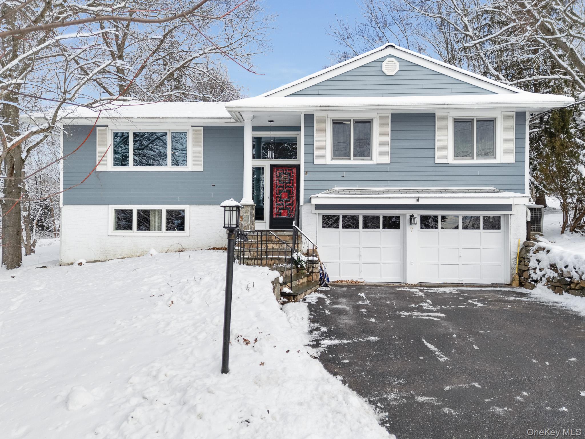 A great place to call home, this raised ranch–style home sits on 0.52 acres and provides inviting living spaces in Ossining, just outside the town center. The foyer leads into a spacious living room with a large bay window that fills the space with natural light. An open layout leads into the formal dining room and continues into a four-season sunroom with oversized windows overlooking the spectacular backyard, creating an ideal setting for get-togethers, summer barbecues, and everyday enjoyment. The space connects seamlessly to the deck, making it easy to enjoy morning coffee or gatherings that move easily between indoors and out. The spacious kitchen features ample cabinetry, granite countertops, a skylight, and a refrigerator designed to blend seamlessly with the cabinetry. The main level includes three generously sized bedrooms and a full bathroom with double sinks. Pull-down attic stairs provide convenient additional storage. The lower level expands the living space with a cozy family room featuring a fireplace, an office or den, a convenient half bathroom, a separate utility room, and direct access to the outdoors. A driveway leads to a two-car garage, completing the property. Ideally located, this home allows you to enjoy the benefits of living in Ossining with close proximity to shopping, dining, parks, and schools, while still feeling removed from the hustle of the town center. Commuters will appreciate easy access to major roadways, including Route 9 and the Taconic Parkway, providing convenient travel throughout Westchester and into New York City.