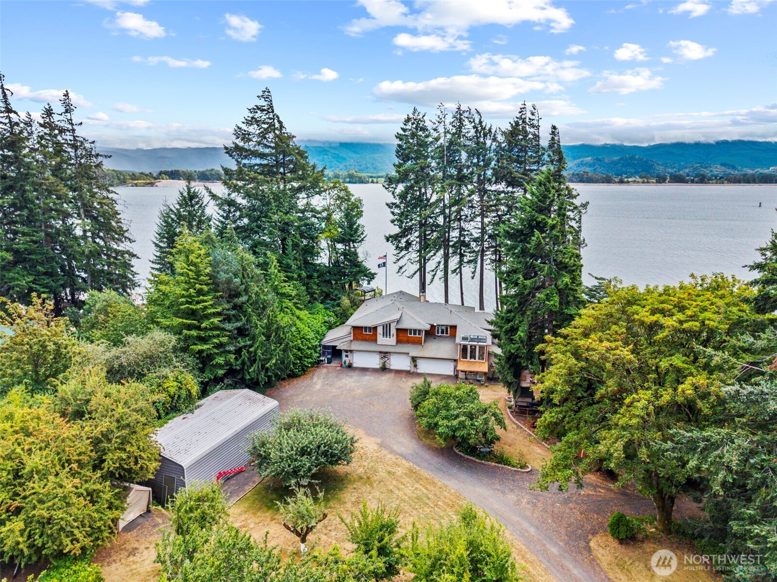 Dreaming of fishing off your own beach? Always wanted to reside at Little Cape Horn, Cathlamet? Well, here is your rarely available opportunity to do just that! Comfortable, contemporary home w/Columbia River VIEWS, beachfront & territorial views for miles! Enjoy 2,616 square feet of living space wi/over an acre of privacy, peace, quality of life & a recreational oasis! Arrive at this property via private road, alongside a white vinyl rail fence, beautiful, mature ORCHARD, covered RV parking, attached side-x-side or tractor storage and pull up to your 8-car garage, Yes, a tandem garage w/more than just parking! Plenty of room to store your toys as well as a second laundry area. Main level, SOARING tiled entry leads you to a one-bedroom ADU w/full kitchen, 3/4 bath w/tiled, roll-in shower, living room w/slider to private deck, pellet stove & lots of windows to appease. Up the beautiful, iron-adorned stairwell you will land at a huge great room with AMAZING river views, walls of windows & a woodstove that grounds this room; trayed ceilings & open to the gourmet kitchen.  Black granite plays off beautiful custom cabinetry built for entertaining and engaging. Large pantry, office space, island and dining area surrounded by breathtaking views. Secondary bedroom, full bath & laundry just off the hall to the ensuite that does not disappoint; large bath, huge w/i closet, door to private spa; primary fireplace, spacious w/soaring ceilings & same amazing views. PLUS a SANDY beachfront!