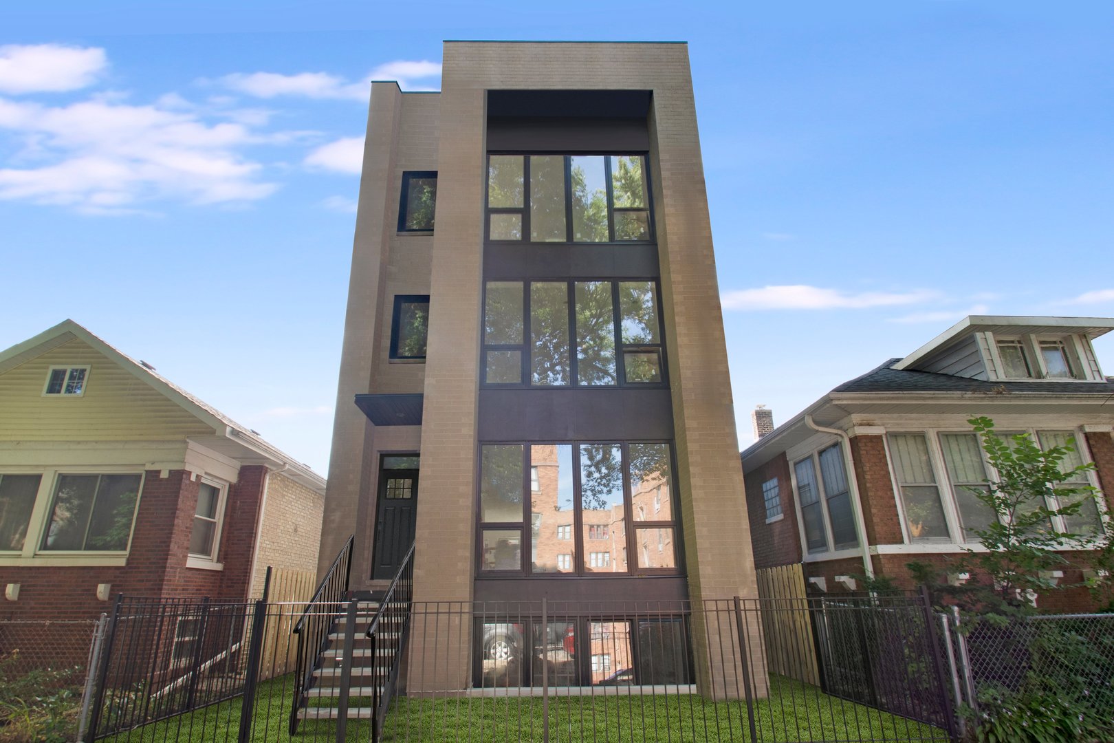 This brand-new, all-masonry 3-unit building sits on an extra-wide lot, offering a perfect single family home alternative. The extra width is noticeable from the moment you enter-wider stairwells, more generous hallways, and an expansive open-concept living space create a sense of volume rarely found in similar homes.    High-end finishes and thoughtful upgrades are featured throughout, including custom cabinetry flanking both sides of the kitchen island, a tankless water heater, heated floors in the primary bathroom, and a walk-in primary closet that's larger than some bedrooms. Every inch has been carefully designed for both comfort and elevated style.  This massive 3,000 sq ft duplex-down lives like a single-family home, with multiple living spaces on both levels and a large, covered rear deck perfect for entertaining. Garage parking is included, and a garage rooftop deck build-out is available as an option.