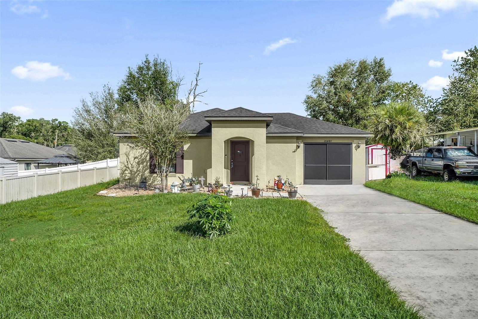 Virtually Staged. One or more photo(s) was virtually staged.2018 BLOCK HOME - NO HOA - OPEN CONCEPT KITCHEN - EXTENDED PAVER PATIO WITH GAZEBO - FULLY FENCED BACKYARD - INDOOR LAUNDRY - Built in 2018, this 2 bedroom, 2 bath concrete block home in Brooksville offers 1,044 square feet of living space with no HOA. The open concept kitchen features stainless steel appliances, an island with a breakfast bar, and a dining area that flows into the living room, where a built-in electric fireplace sets the tone. Laminate floors run throughout, making the home easy to care for, and an indoor laundry room. Outside, the extended brick paver patio with a gazebo is ready for evenings outdoors, and the fully fenced backyard with solar lights has a storage shed for your tools. The screened garage has wall to wall storage and shark coated floors, and gutters run all around the home. Schedule your showing today.