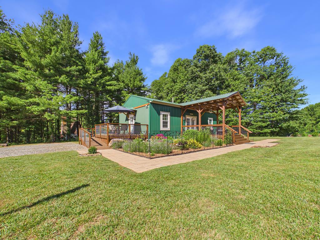 Gorgeous Getaway located in the Park Ridge community just off the Blue Ridge Parkway in beautiful Floyd County. Built out in 2023, this small home has big appeal. Each of the two large bedrooms have their private bath with an open kitchen & living room in between. Eachbedroom has a separate entrance to a private deck. The three mini-splits provide zoned heating & air in each room. Enjoy the morning birdsong fromthe expansive timber frame covered front porch overlooking the flower garden & expansive yard. With over 1.6 acres, there is room to constructanother home & room for a garden. RV parking is available with 30 amp power & septic dump. The 20x30 building can be used as a garage &workshop. The house has a generator hookup. When not relaxing in your private oasis at the end of a cul-de-sac drive, you can take advantage of allthe amenties Park Ridge has to offer including an in-ground heated pool, club house, stocked lake (visited by geese, eagles & osprey), ATV trails.