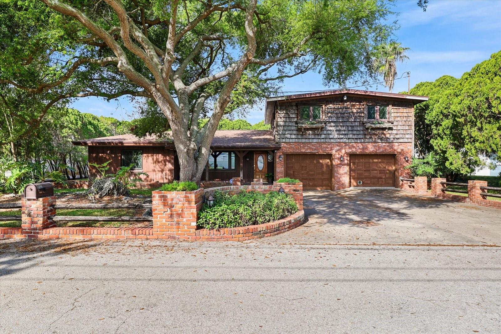 This one-of-a-kind Clearwater home is full of character and meticulous craftsmanship. This 3-bedroom + office (easily convertible to a 4th bedroom), 2-bath block home features exquisite custom woodworking throughout, TWO gas fireplaces, an extended family room, solar tubes for additional natural light, a gas stove in the kitchen, and a custom built-in bar perfect for entertaining. The oversized second bay in the 2-car garage provides extra storage or workshop space.The primary suite is conveniently located downstairs with a walk-in closet, while three additional bedrooms are upstairs, featuring newer luxury vinyl plank (LVP) flooring. The home also includes a first-level office and laundry room with wash sink and shower.Major updates include: Newer roof (2024), newer AC (2024), tankless water heater (2025), and septic serviced/emptied (2024).While the home retains its original style and vintage aesthetic, buyers will appreciate the exceptional craftsmanship, solid block construction, and incredible potential to update while preserving its unique architectural character. This centrally located property offers space, flexibility, and timeless charm.The nearby Duke Energy Trail is great for biking or walking and this home is zoned for schools with high ratings. It is centrally located near shopping, dining, airports, Tampa bridges, and Clearwater’s world-famous beaches. Don't miss the chance to see this beautiful unique home.