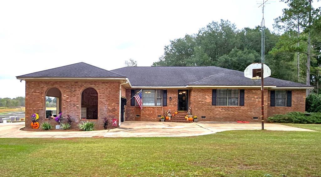 Designed for entertaining and everyday comfort, this stunning brick home sits on 2.34 acres just outside of Bainbridge and offers a rare combination of space, privacy, and year-round water views. Overlooking a peaceful pond beside the gorgeous pine and oak trees, this home is surrounded by inviting outdoor living spaces — including multiple decks, patios, a sparkling in-ground pool, and a pergola — this home was built for gatherings and relaxation. Inside, you'll find two primary suites on the main floor, four full baths, and a spacious, light-filled layout perfect for family or guests. The main level features a large eat-in kitchen, a cozy brick fireplace, and generous storage throughout. The finished walk-out basement expands your options even further — complete with a full kitchen, bath, and open living area ideal for entertaining, a guest suite, or a home theater.                               Outdoors, a new 40x60 pole barn and separate storage building, and fenced in area provide incredible versatility. The pole barn even includes a partially finished living or work area, offering endless potential for hobbies, a studio, or home office. With thoughtful updates, and space to spread out both inside and outside, this property delivers the perfect blend of comfort, functionality, and lifestyle.                  Welcome home to your private retreat.