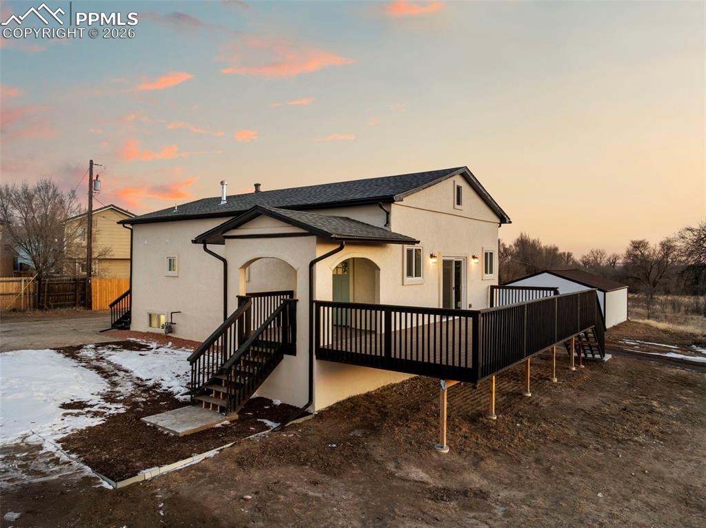 Welcome to 6801 End of the Trail, a truly one-of-a-kind property offering nearly 4 acres of agricultural-zoned land, ideal for livestock, horses, and future expansion. Positioned just west of a nearby development, this elevated and private setting delivers unobstructed, sweeping views of Pikes Peak and the Front Range across Fort Carson—views that simply cannot be replicated. Along with feeling secluded, the property is only 7 minutes from Fort Carson Gate 20 and just minutes from downtown Fountain, Fountain Creek Regional Park, I-25, and more, offering the perfect balance of convenience and seclusion.The property remains unincorporated while benefiting from its own high-producing well and being newly permitted and connected to city sewer, a rare and valuable combination. The land is fully fenced and gated, includes an oversized detached garage, and features a mix of mature trees and flat, usable acreage, ideal for barns, stables, workshops, or future development.Here is the best part: the home has been fully gutted and remodeled with permits, inside and out. Updates include new stucco exterior, a large composite deck designed to capture the stunning views, and complete upgrades to electrical, plumbing, and mechanical systems, along with a new well pump and upgraded electrical service. Inside, an open-concept design highlights a brand-new kitchen with stainless steel appliances, tub basin sink, and island flowing seamlessly into the dining and living areas with a walk-out slider that frames the Front Range. The renovation also added a primary bathroom and an additional half bath, enhancing both comfort and functionality.This is a truly rare offering—a serene, private Colorado retreat with breathtaking views, usable acreage, and endless possibilities, all while remaining close to Fort Carson and city amenities.