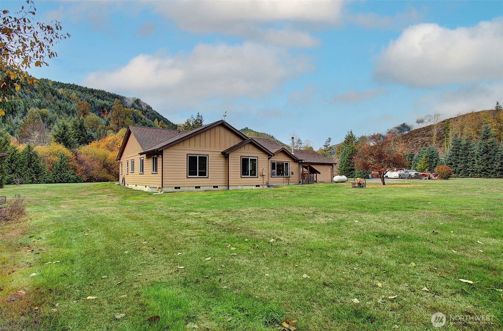 Hard-to-find single-level, no-step home on 5 private acres with room to grow and a creek—perfect for outdoor enthusiasts. This 2,208 sq ft home (built 2012) offers 3 beds, 2.5 baths, and a bright open-concept layout with vaulted great room and abundant natural light. Spacious kitchen features granite counters, large island w/bar sink, propane cooktop, convection oven, built-in microwave, birch cabinets, and walk-in pantry. Living area with cozy wood stove. Primary suite includes walk-in closet, patio access to hot tub, and accessible shower w/dual heads. Flexible space for guests or office. Guest bath with split layout and dual sinks. Features: 400 AMP service, Lennox heat pump, tankless hot water, 24x33 heated garage w/workshop space, no-step entry, wide doorways, mudroom/laundry. Private well (1,700-gal reservoir), septic, 16KW generator, RV hookup, pumphouse w/loft. Circle driveway, private walking path through wooded acreage to your own creek, fenced orchard, abundant wildlife. Plenty of room to build a shop. Peaceful Glenoma setting just ¼ mile to Hwy 12. White Pass Ski Area ~30 min, Riffe Lake ~10 min. Views of Kiona Peak.