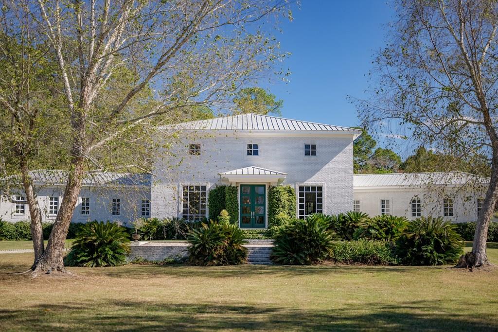 Sophisticated Country Living in Cairo, Georgia Nestled on 30 pristine acres, this contemporary 4 bedroom, 4.5 bathes country estate is a masterclass in “casual but elevated” living, where architectural integrity meets effortless maintenance. Designed by noted architect Reynolds Brown with interiors by BROWNWORKS, LLC, the residence is defined by a sense of volume and light, anchored by 24-foot ceilings in the primary living areas. The aesthetic is both modern and deeply rooted in the land's history, featuring log beams and reclaimed heart pine floors —both salvaged from the property's original structures. The primary suite serves as a true private sanctuary, featuring his and her closets, double vanities, and a luxury spa-like bathroom setting. The chef's kitchen is a functional piece of art, showcasing furniture-grade Biedermeier-style cabinetry, sleek black honed granite and high end appliances. Every element of the home was chosen for its permanence and understated beauty, utilizing a palette of premium materials that ensure the home is as easy to live in and maintain as it is striking to behold.  Beyond the main residence, a private one-bedroom pool house and saltwater pool create a serene setting for quiet afternoons or grand-scale entertaining. The acreage offers a quintessential rural lifestyle, featuring a small pecan orchard, mature citrus trees, and a fenced pasture ideal for those looking to engage with the land. While the estate feels like a world of its own, it remains perfectly positioned to enjoy the region's plentiful cultural amenities, from premier outdoor recreation and local country clubs to the refined charm of the nearby towns of Cairo and Thomasville. This property is more than a home; it is a retreat that balances the quiet rhythms of country life with the sophisticated comforts of a modern architectural masterpiece. With too many upgrades and bespoke features to mention, this property must be viewed to fully appreciate the level of craftsmanship and detail provided. For those seeking a truly turnkey experience, the residence and a selection of its custom furnishings may be made available.