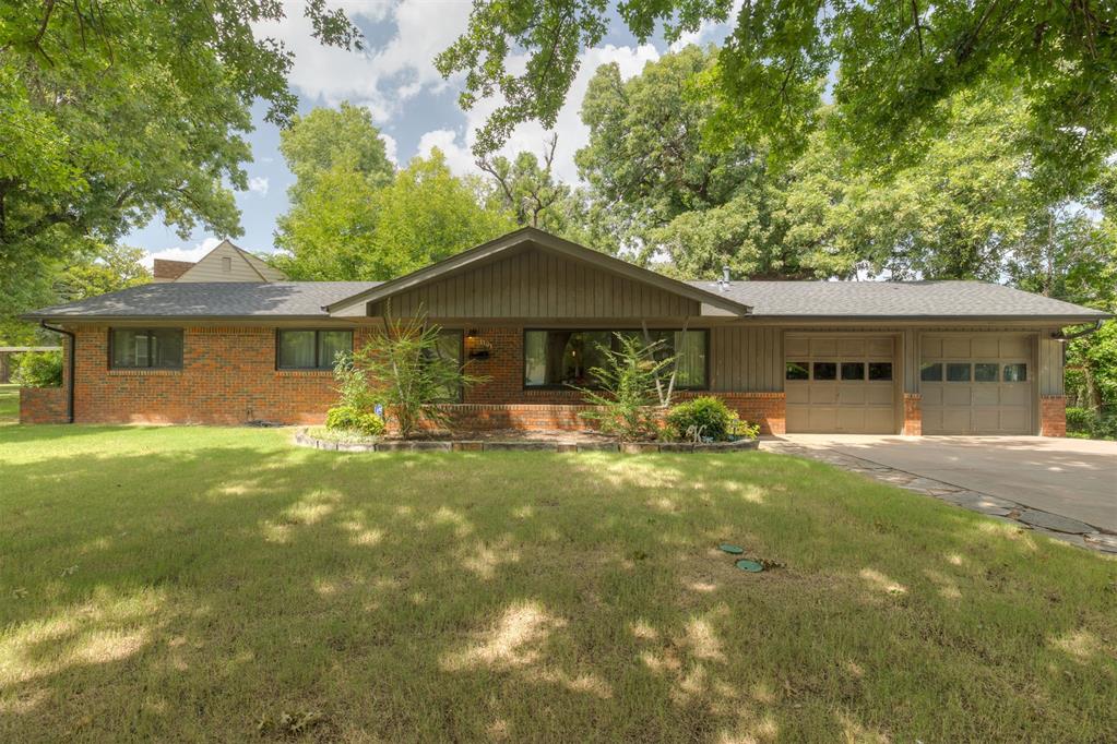 LOCATION, CONDITION and a KNOCK-OUT primary bathroom! This Brookhaven Beauty is nestled in the heart of all the best shopping and restaurants in OKC. RARE FIND; 3/2 with one of the only TWO car garages in the addition. Walk to Classen Curve, Whole Foods and more. This property is loaded with historic character and updated with modern finishes. Kitchen features solid surface countertops, pantry and stainless appliances; including 5 burner gas cook top, built-in oven and dishwasher. Completely remodeled primary bath with double vanities, gorgeous quartzite countertops, raised ceiling, custom marble tiled shower and designer finishes is the star of the show! Charming hall bathroom with nostalgic pink tile and built-in dressing table. Most windows replaced with Renewal by Anderson in the last 2 years. Front yard sprinkler system installed Fall of 2025. Backyard is a shady oasis; Deep Fork Creek runs through with foot bridge, grassy areas, even a hidden vintage firepit; a true oasis in the heart of The Western Avenue District. Easy access to I-44.