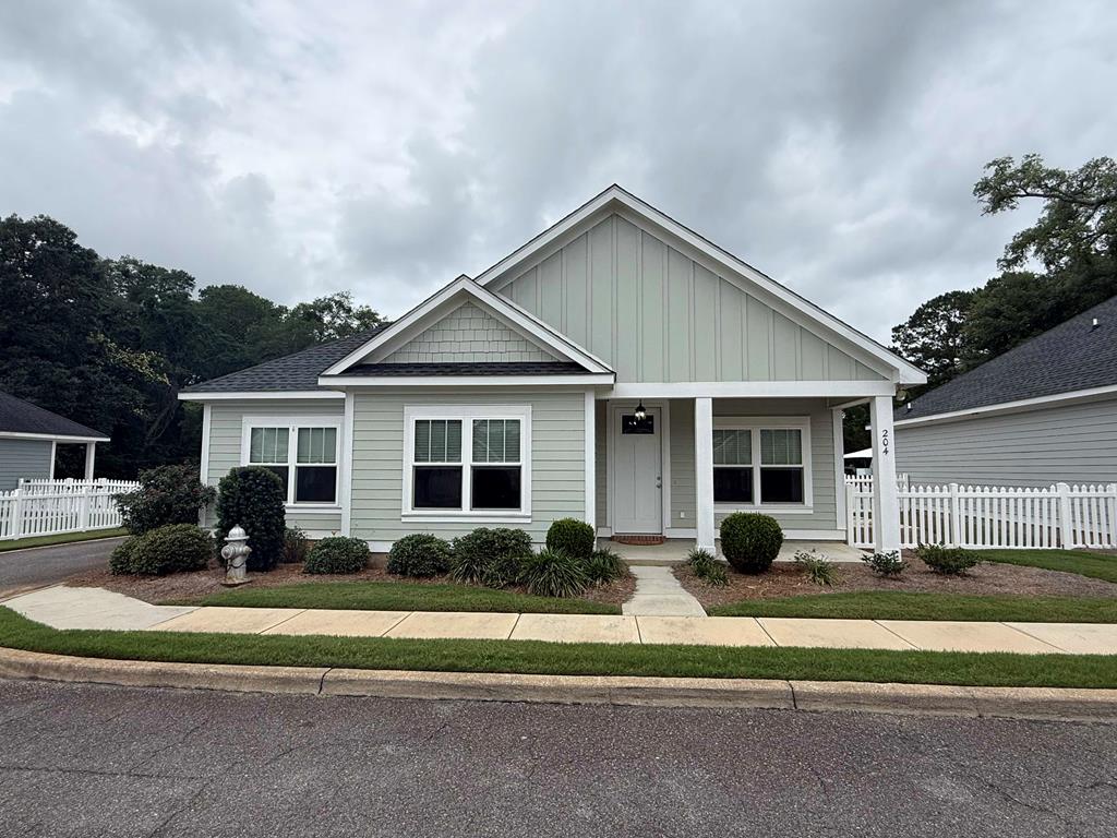 Welcome to Madison Grove living at its finest! This beautifully designed 3-bedroom, 2-bath home offers the perfect blend of modern farmhouse charm and low-maintenance living. From the moment you arrive, you'll appreciate the attractive curb appeal featuring board and batten accents, architectural details, and a welcoming covered front porch, all complemented by a low-maintenance lawn for where upkeep is done for you.  Inside, the thoughtfully designed open floor plan is filled with upscale finishes including luxury vinyl flooring, granite countertops, stainless steel appliances, and custom tray and coffered ceilings that add character throughout the home. The spacious living area flows seamlessly into the kitchen and dining spaces, creating an ideal setup for both everyday living and entertaining.  The primary suite offers a relaxing retreat complete with a tray ceiling, sliding barn door entry into the ensuite bathroom, double vanity, beautifully tiled walk-in shower and an attached walk-in closet. The additional bedrooms provide flexibility for guests, family, or a home office.  Enjoy outdoor living with a private patio space perfect for relaxing or entertaining. Located in the desirable Madison Grove community, residents enjoy access to neighborhood amenities including a clubhouse, fitness center, and community swimming pool.  Conveniently located near shopping, dining, and everyday conveniences, this home combines comfort, style, and community amenities all in one.