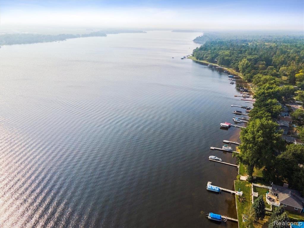 Lakefront living on all-sports Van Etten Lake and a couple miles from Oscoda Beach Park on Lake Huron! This turnkey fully furnished 3-bedroom, 2-bath home offers 48 feet of prime waterfront and 1,335 square feet of thoughtfully updated space. Recent upgrades include a brand-new mini split heating and cooling system (2025), a third bedroom addition (2025), and a gas log fireplace insert (2023/2025) that efficiently warms the entire home. You'll love the open feel created by large windows that flood the space with natural light and offer incredible lake views. Both bedrooms feature new laminate flooring (2023), and the kitchen is equipped with sleek stainless appliances (2022). The updated septic system adds peace of mind, while the fully fenced lakeside yard with dual access gates makes outdoor living easy and private. Step out onto the expansive 560 sq ft treated deck—perfect for entertaining—or head down to your private wooden dock for a day on the water. Whether you’re looking for a weekend retreat or year-round living, this move-in-ready lakefront property has it all. This home is just 15 miles from downtown East Tawas and a couple miles from the start of the Au Sable River Shoreline Park & Boat Launch!