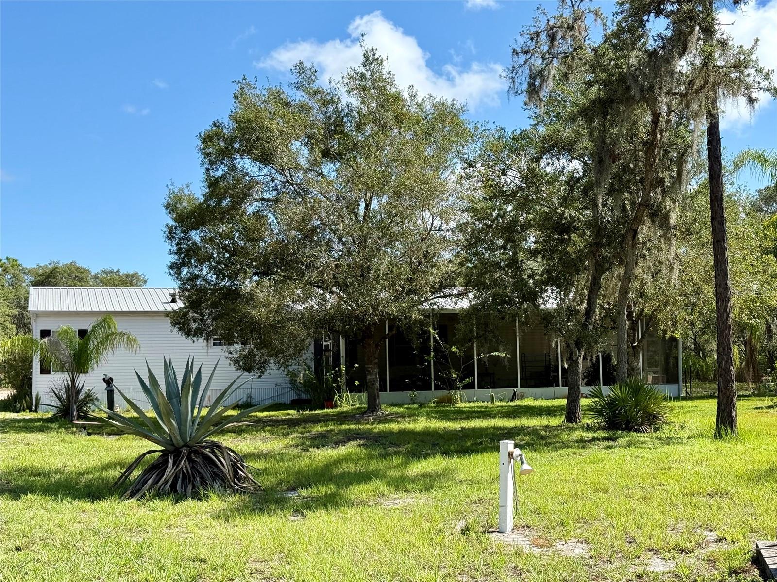 MR "FIX IT!" JUST RIGHT FOR THE GUY WHO NEEDS LOTS OF WORKING SPACE! THIS PROPERTY BOASTS A 24X52 METAL BUILDING/GARAGE WITH A 12X52 LEAN TO ON ONE SIDE & ANOTHER 14X52 LEAN TO ON THE OTHER SIDE OF THE METAL BUILDING! PLENTY OF ROOM FOR VEHICLES & PLENTY OF WORKING SPACE!!!  PLUS THERE IS ALSO A 14X18 POLE BARN FOR EXTRA PARKING IF NEEDED! ALL THIS PLUS A 4 BEDROOM 2.5 BATH MANUFACTURED HOME NESTLED AMONG MANY OAK & OTHER TREES ON THIS WOODED LOT! The 1836 s.f. of living area has plenty of room for everyone! There are 3 bedrooms and one bath one one side of the home with the primary en suite on the opposite side of the home! Two of the three bedrooms are 13x13 & have walk-in-closets! The combined living-dining room combo has laminate flooring, 2 ceiling fans & conveniently located just off the kitchen which is open to the family room! The spacious primary has a walk in closet and the bathroom has a tub and separate shower! The utility room has a washer, dryer and freezer. There is a 12x38 front screened porch & a 12x35 back porch to expand every-day living! The roof and one screened porch were replaced in 2017. The Lenox HVAC was purchased in 2020. DON'T WAIT TOO LONG! THIS HOME IS SITUATED IN THE BACK OF BLUE JORDAN FOREST WHICH IS FULL OF WILDLIFE! ENJOY FAMILY, FRIENDS, AND NATURE!