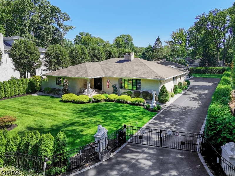 Extraordinary and rare 1980 built brick mother/daughter style ranch in Cranford, NJ! 4,000 square feet! This home has 5 bedrooms and 5 full bathrooms, separated with 3 beds and baths in the main living space, and 2 bedrooms and baths in the in-law suite. State of the art heating and air-conditioning with hot water baseboard heat and 3 systems of cooling. Enjoy one-floor living separated entirely and indepedently by the garage, with three garage parking spaces and a gated driveway. This home has EVERYTHING! FOUR fireplaces, sunk-in living room, granite countertops, stainless steel appliances, overhead vent, two primary suites with ample closet space, and separate washer/dryer areas. The backyard includes covered patios and a sprawling green yard. Enjoy privacy like no other on a dead-end street in Cranford, NJ!