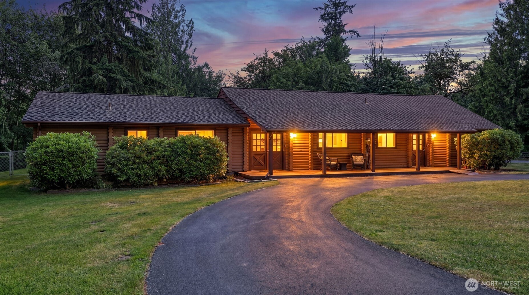 Surrounded by open space & mature landscaping, this log rambler offers a distinctive blend of character and functionality. Situated on just over an acre, the property showcases vaulted ceilings, flexible floor plan, detached shop, covered RV storage, & plenty of room to enjoy the outdoors. This 3 bed, 2.25 bath features large open spaces, oak flooring, warm wood accents, & multiple areas for relaxing, gathering, & entertaining. The kitchen is equipped with a center island, breakfast bar, SS appliances, built-in desk area, & generous storage. The dining area connects seamlessly to the main gathering rooms, creating an easy flow throughout the home. The primary suite includes a private ¾ bath & dual closets, while additional bedrooms & bonus areas provide versatility for a variety of uses. Interior highlights include ceiling fans, double-pane windows, a pellet stove, & electric heating. Recent improvements include a furnace installed in 2023 & water heater installed in 2024. The home is also wired for a generator. Outside, the level grounds include a fully fenced yard, garden space, deck, paved access, & abundant parking. An approximately 18' x 25' detached shop provides an ideal setting for projects, storage, or hobbies. The detached 2-car garage includes a 220-volt outlet, while covered RV parking adds even more flexibility. Combining usable acreage with a convenient Kent location, this home is just minutes from shopping, dining, & major commuting routes.
