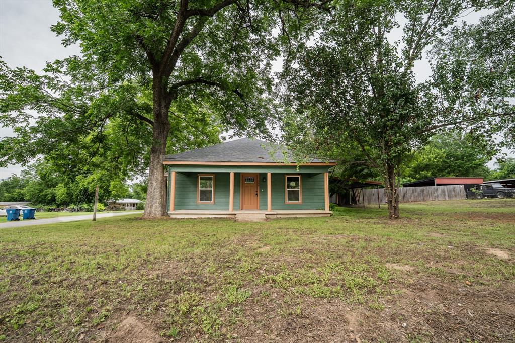 This updated craftsman-style three-bedroom gem, perfectly situated on the northwestern edge of charming Winnsboro near Lake Winnsboro and Lake Cypress Springs, is officially ready for its new owners. The home welcomes you with a large concrete front porch and a shady yard ideal for rocking chairs. Inside, you'll find a bright interior with fresh paint and recessed lights. Luxury vinyl plank flooring provides an elegant look that flows throughout the home. Enjoy the new stainless steel appliances which includes a side-by-side refrigerator, stove, microwave, and dishwasher. The family cook will also appreciate the granite countertops and modern touches in the kitchen. The primary bedroom includes a walk-in closet with custom built-ins, plus a barn door that leads to a spa-like bathroom with a tiled, walk-in shower and a double vanity. In the spacious backyard, you'll find a covered back porch, massive tree for shade, and privacy wood fencing. To top it off, you have a 1-car carport with a side entry into the home. Find this delightful place just a short walk from downtown Winnsboro.